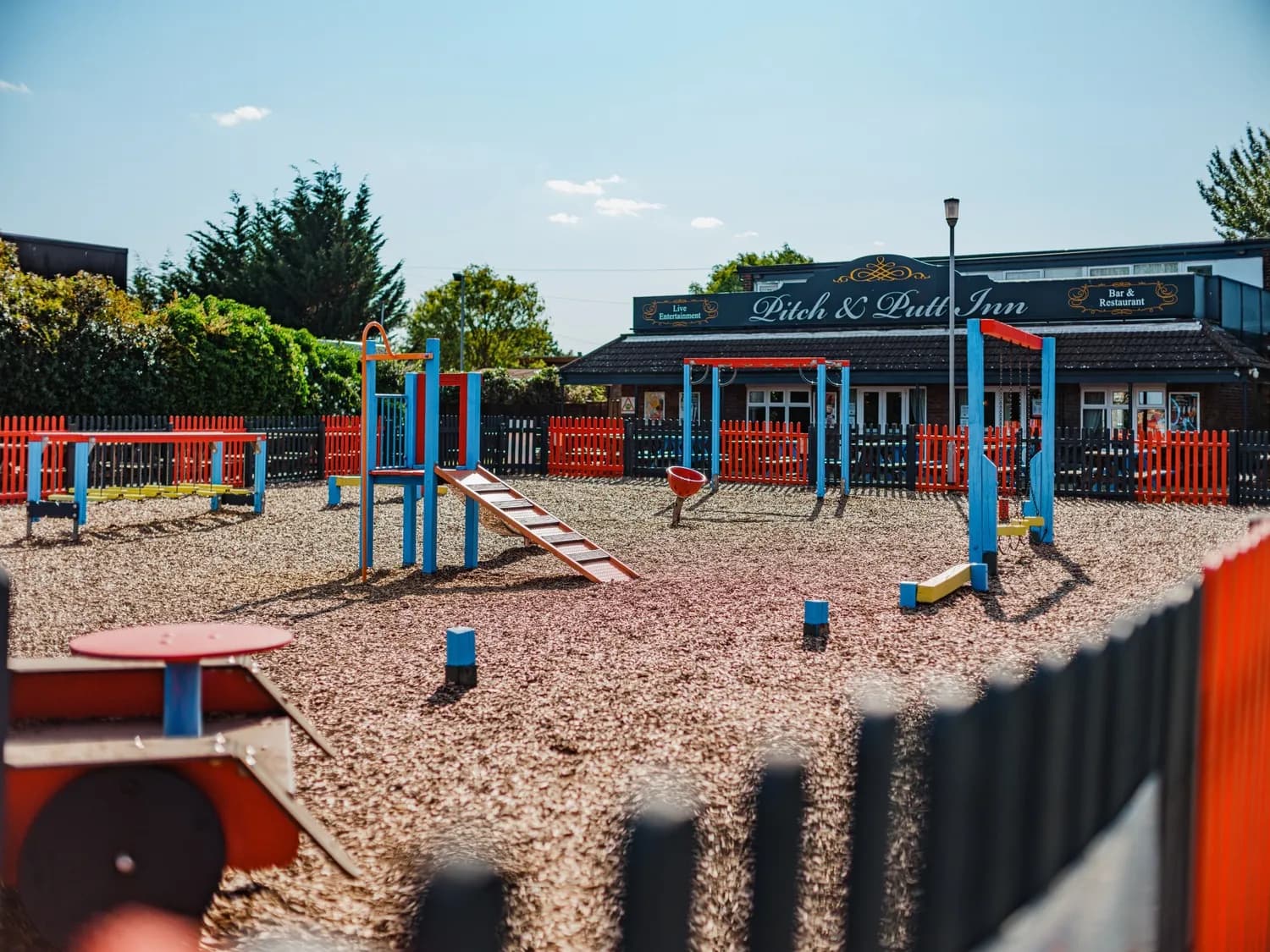 North Shore Pitch & Putt Childrens Play Area with Restaurant in Background