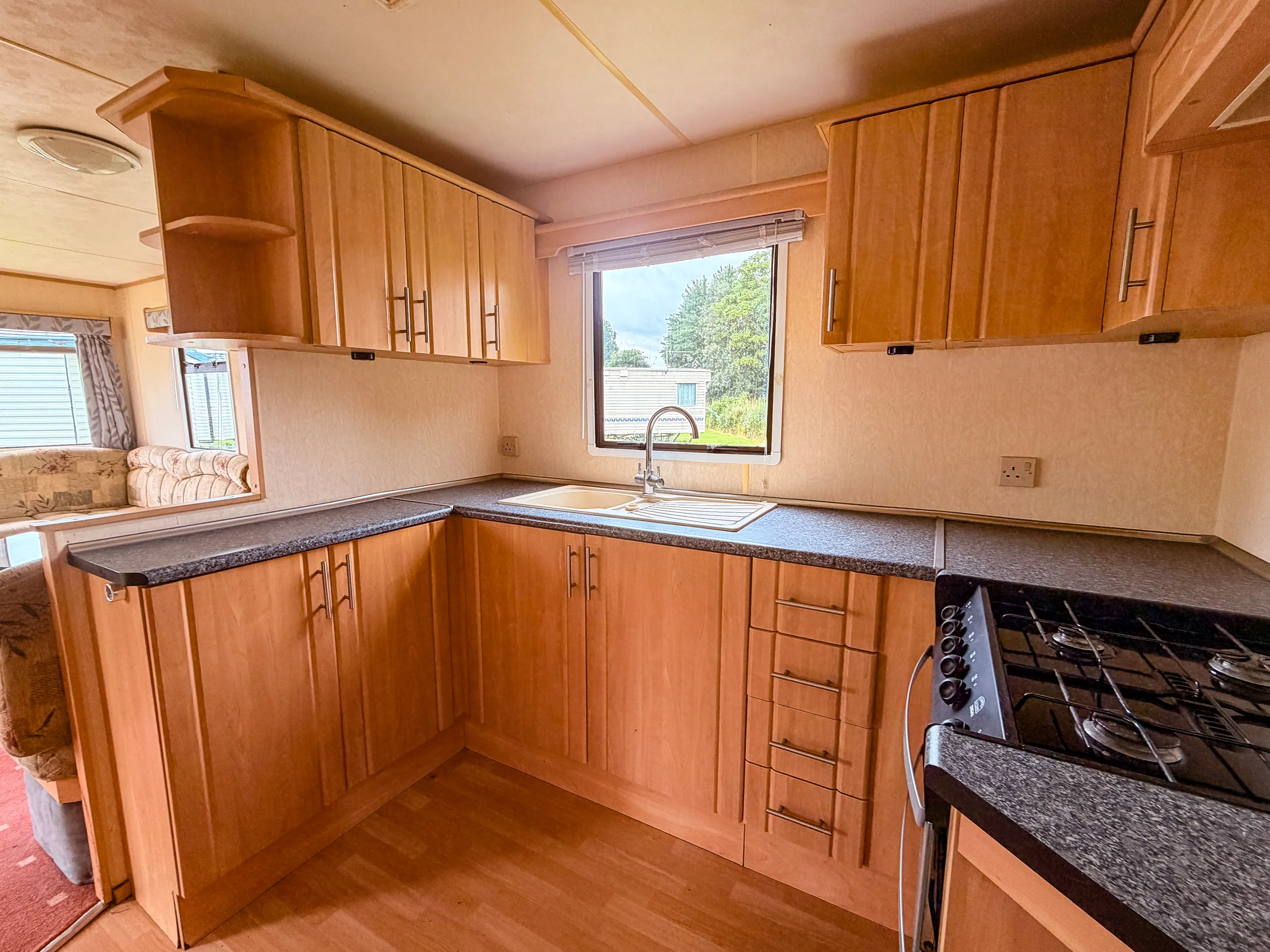 ABI Colorado interior view of an oak kitchen with sink, built in cabinets and drawers