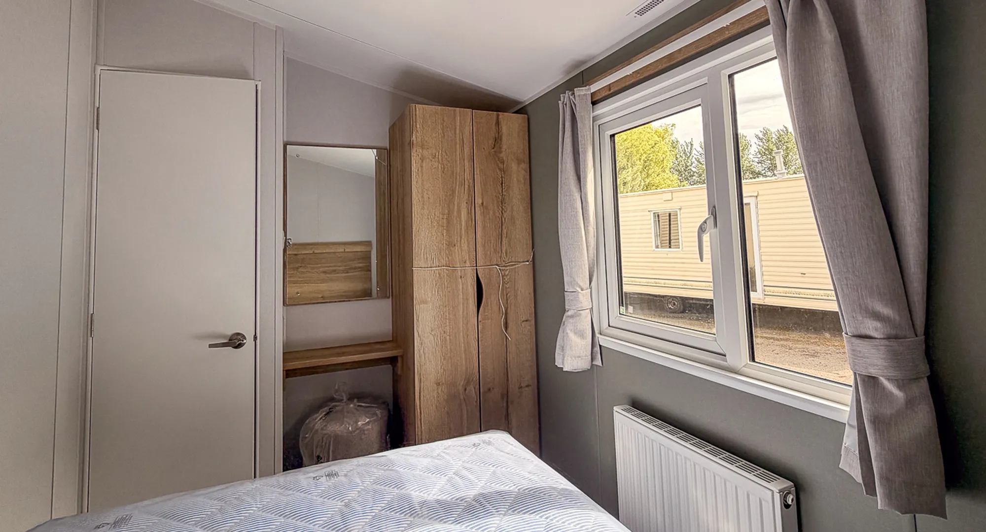 secondary view of the master bedroom with dressing table and wardrobe