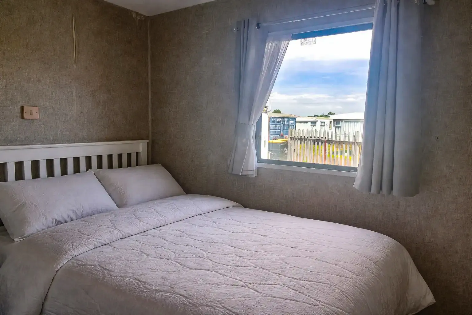 Master bedroom with double bed and fitted storage in the 2003 ABI Arizona