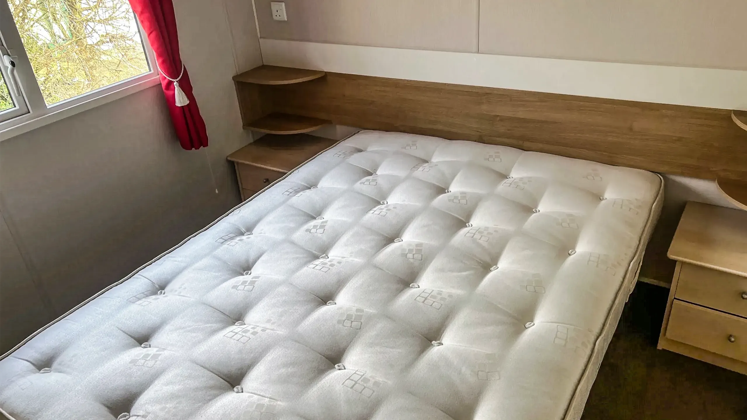 Main bedroom with double bed and night stands in a 2015 Willerby Vacation in Lincolnshire