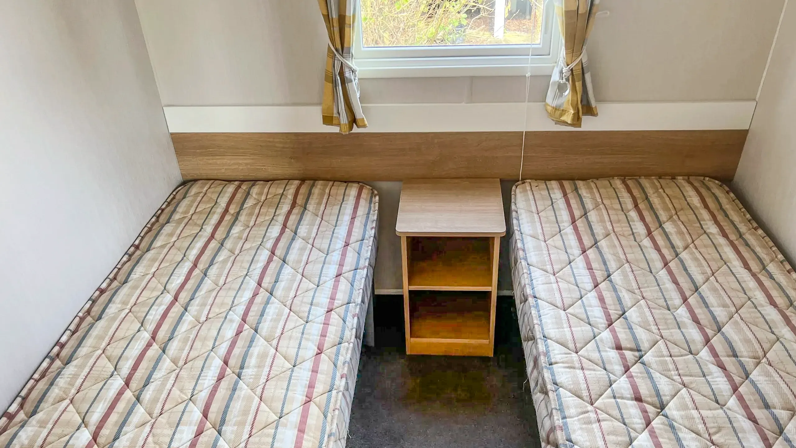 twin bedroom with shared nightstand on a 2015 Willerby Vacation for sale at Roach Farm in Skegness