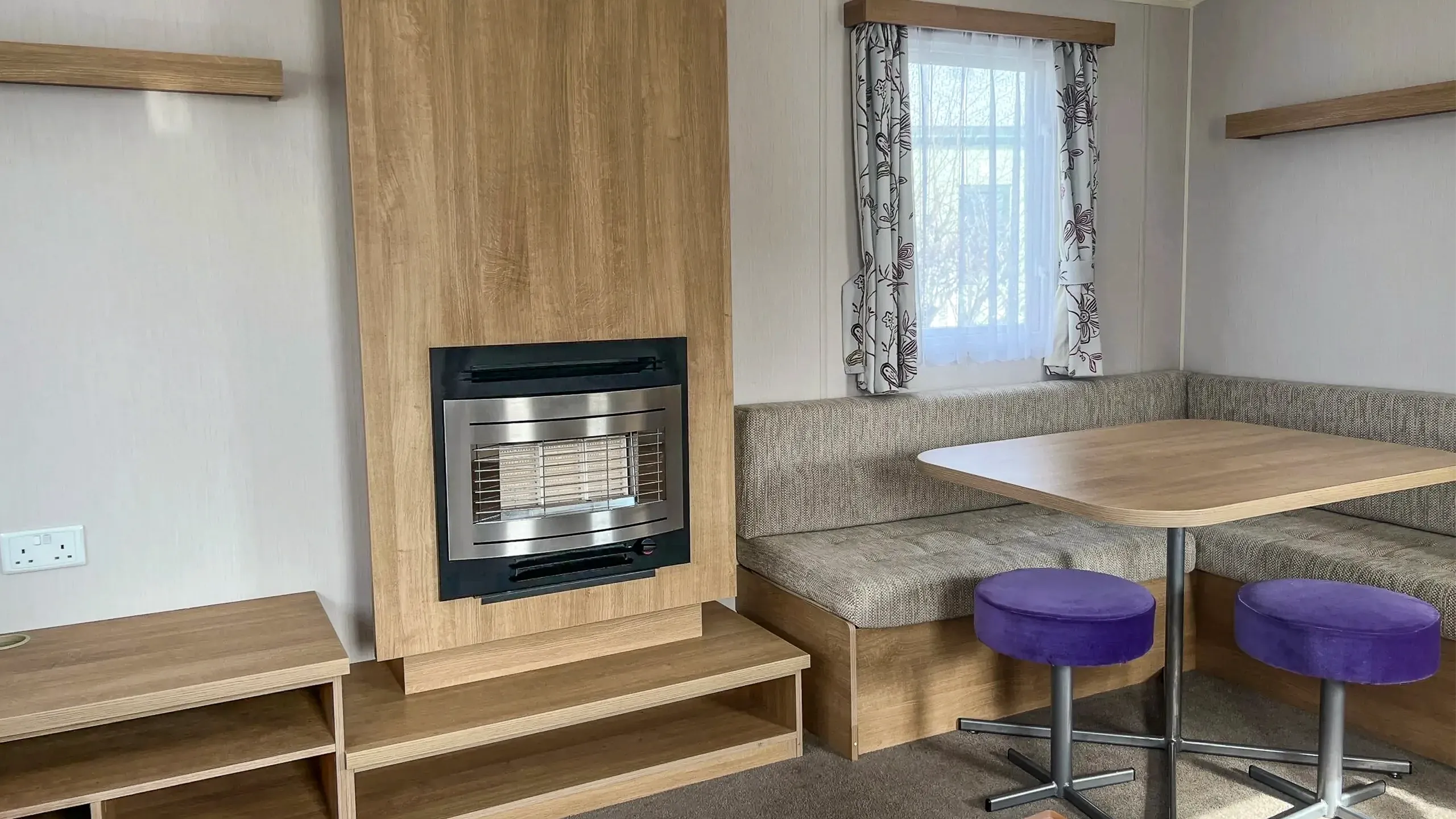 Built in dining area and fireplace with shelving inside 2015 Willerby Vacation Caravan
