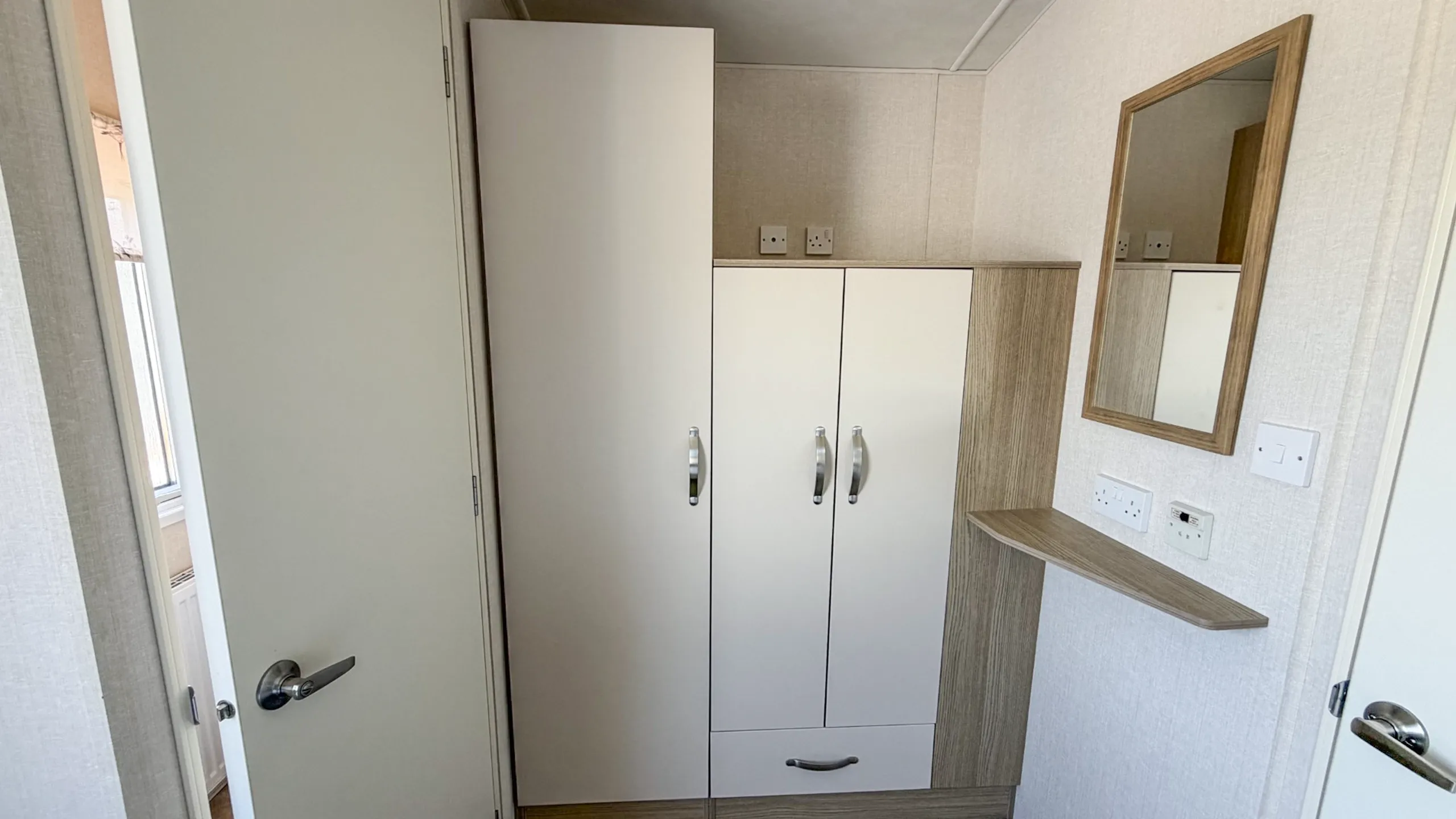 another view of the main bedroom showing the built in wardrobe