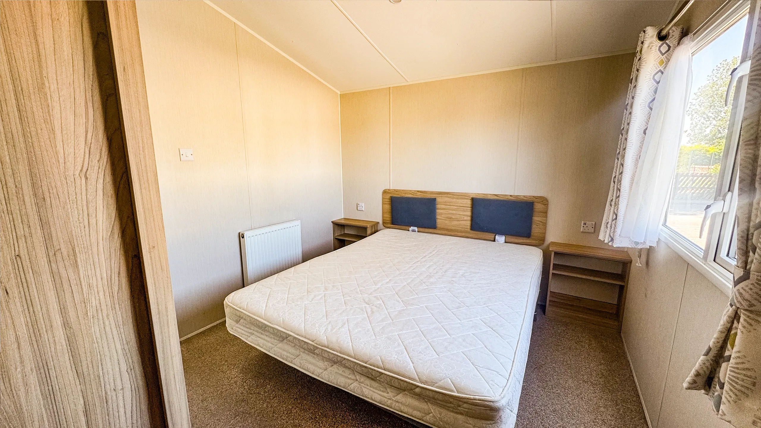 Main bedroom with large bed and night tables, 2021 Willerby Malton