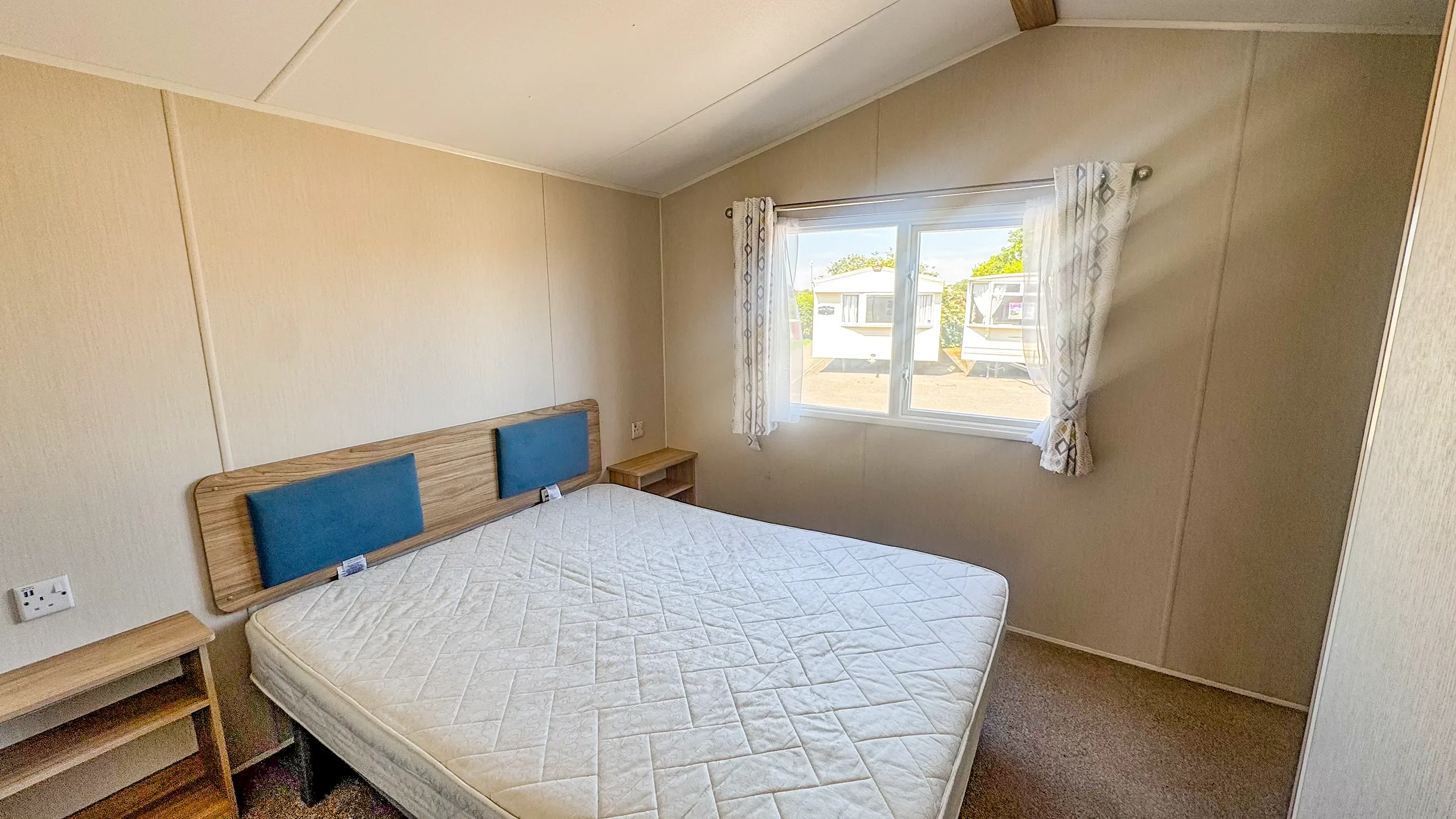 large window at side of main bedroom letting in lots of natural light