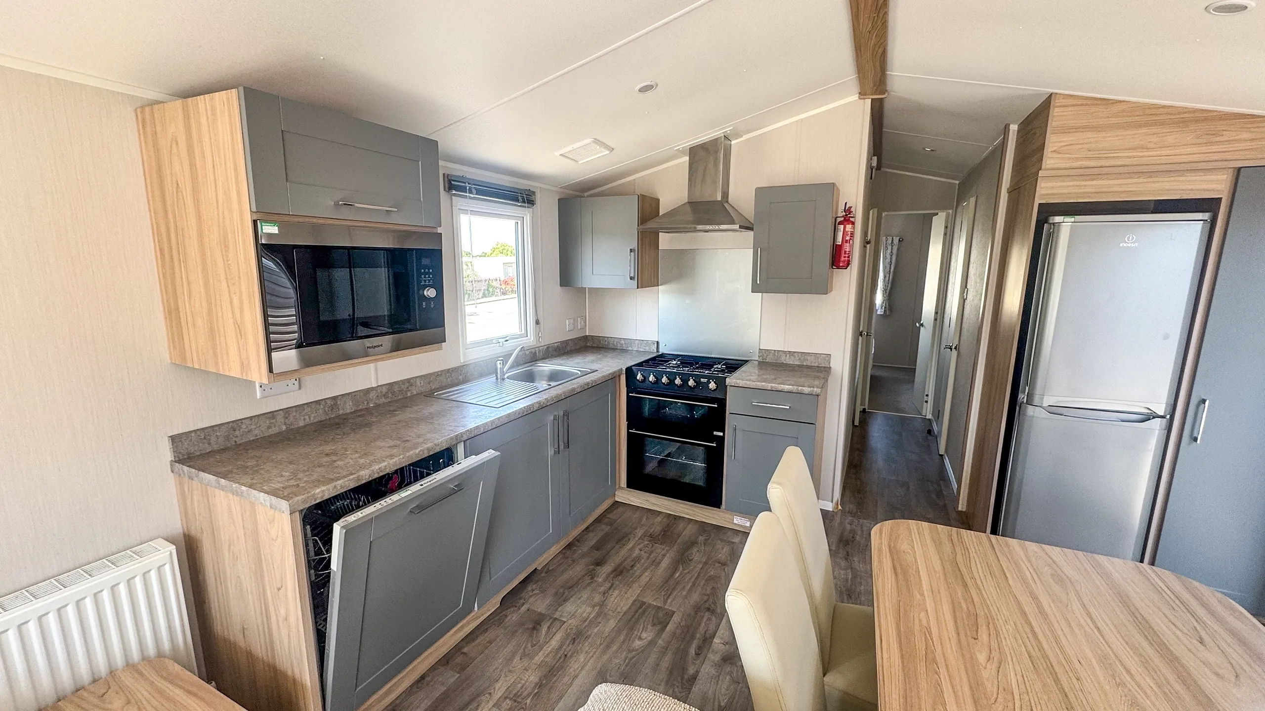 kitchen with black cooker and built in dishwasher with microwave overhead
