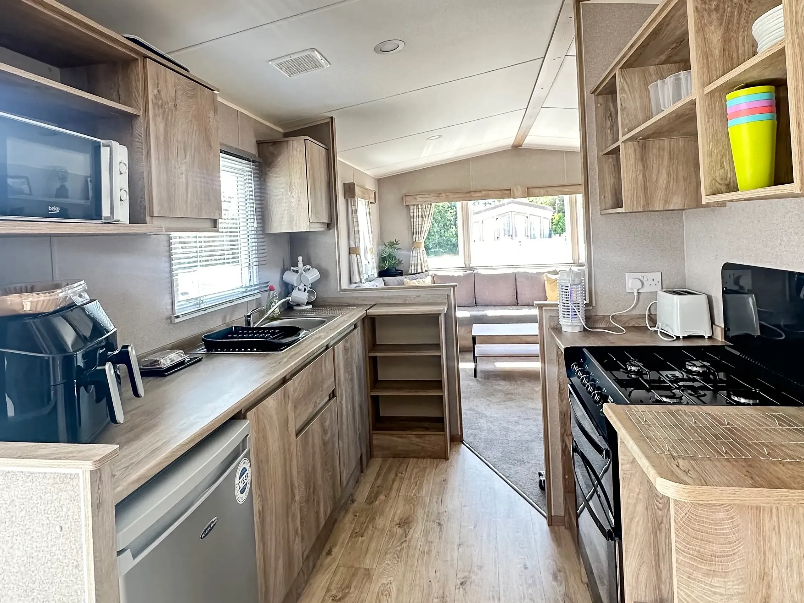 kitchen with appliances and light wood cabinets in modern 2026 ABI Seaspray