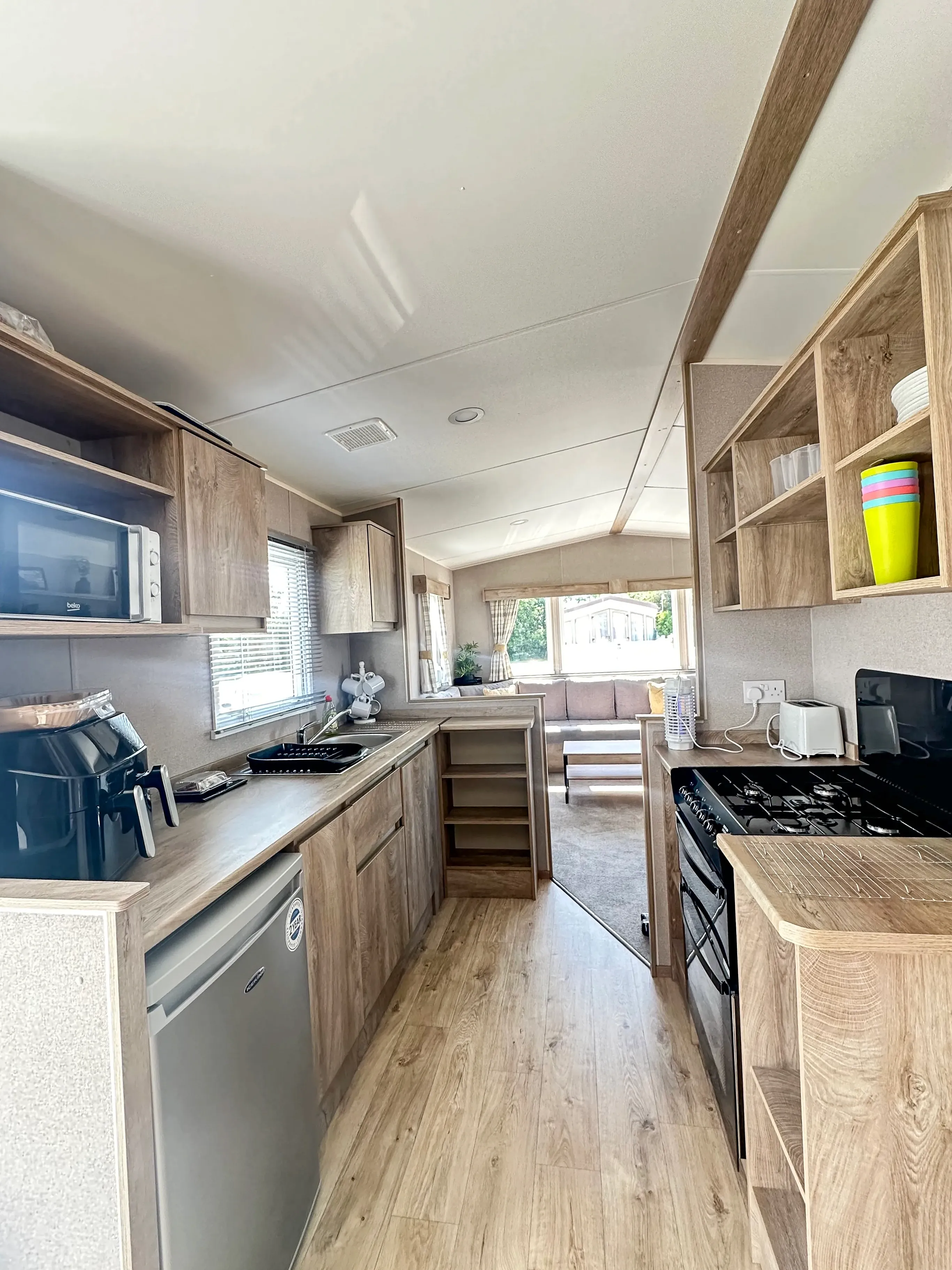 kitchen with appliances and light wood cabinets in modern 2026 ABI Seaspray