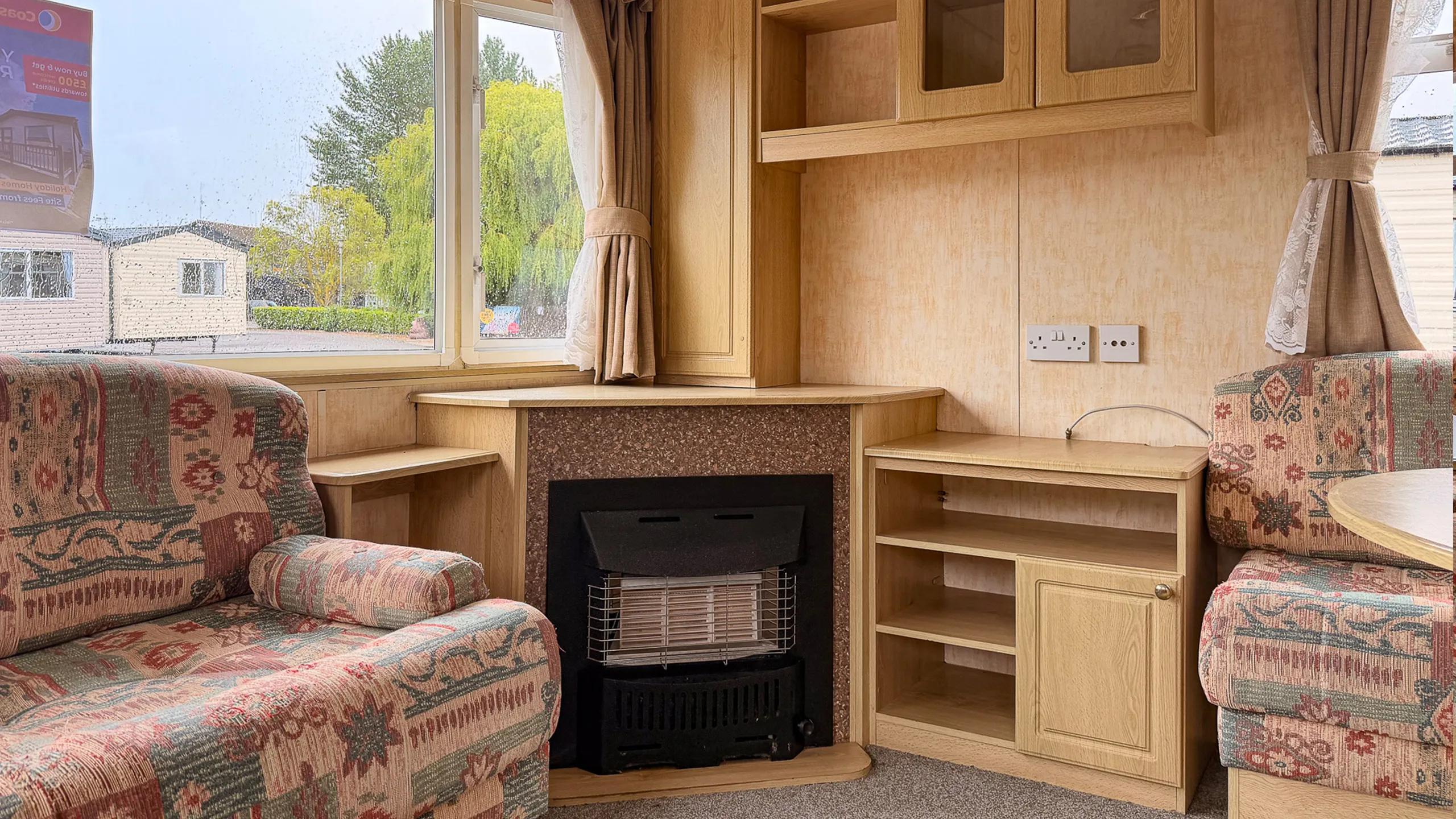 Inside static caravan holiday home fireplace and built in shelfing in oak wood