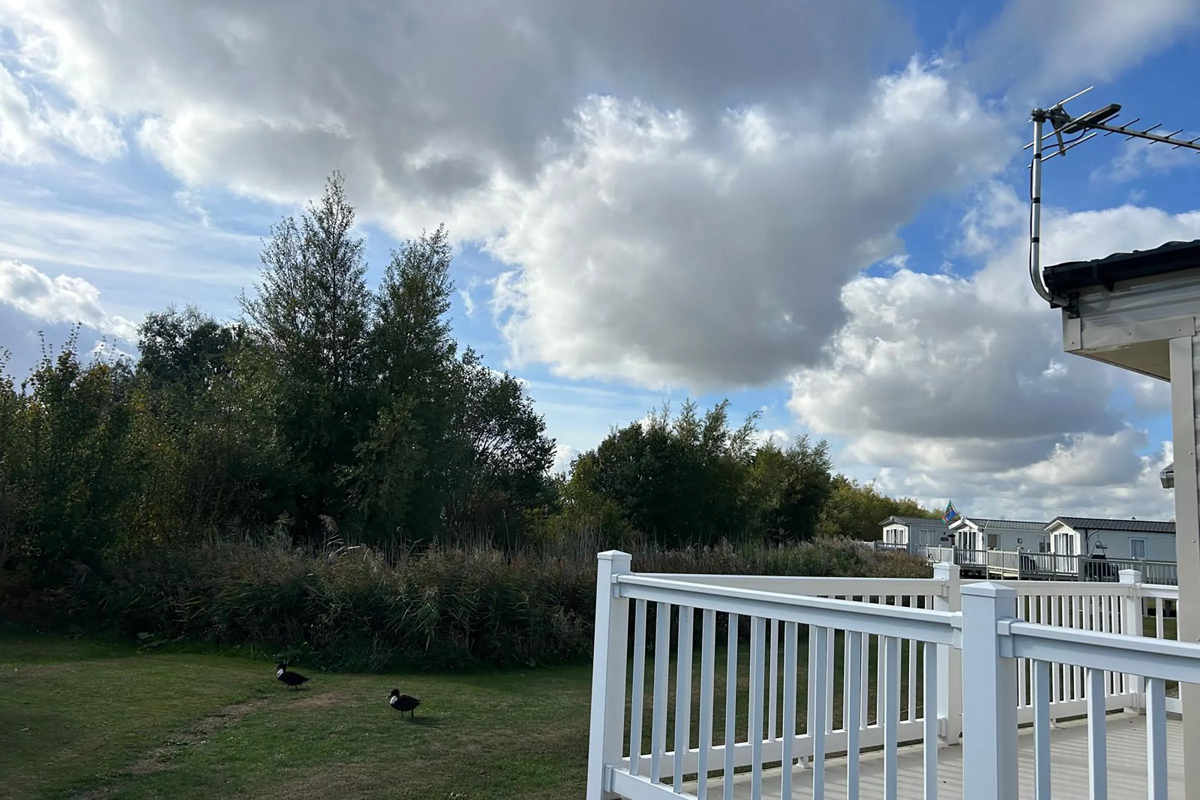 2018 Willerby Mistral Coastfields exterior with decking and picturesque pitch