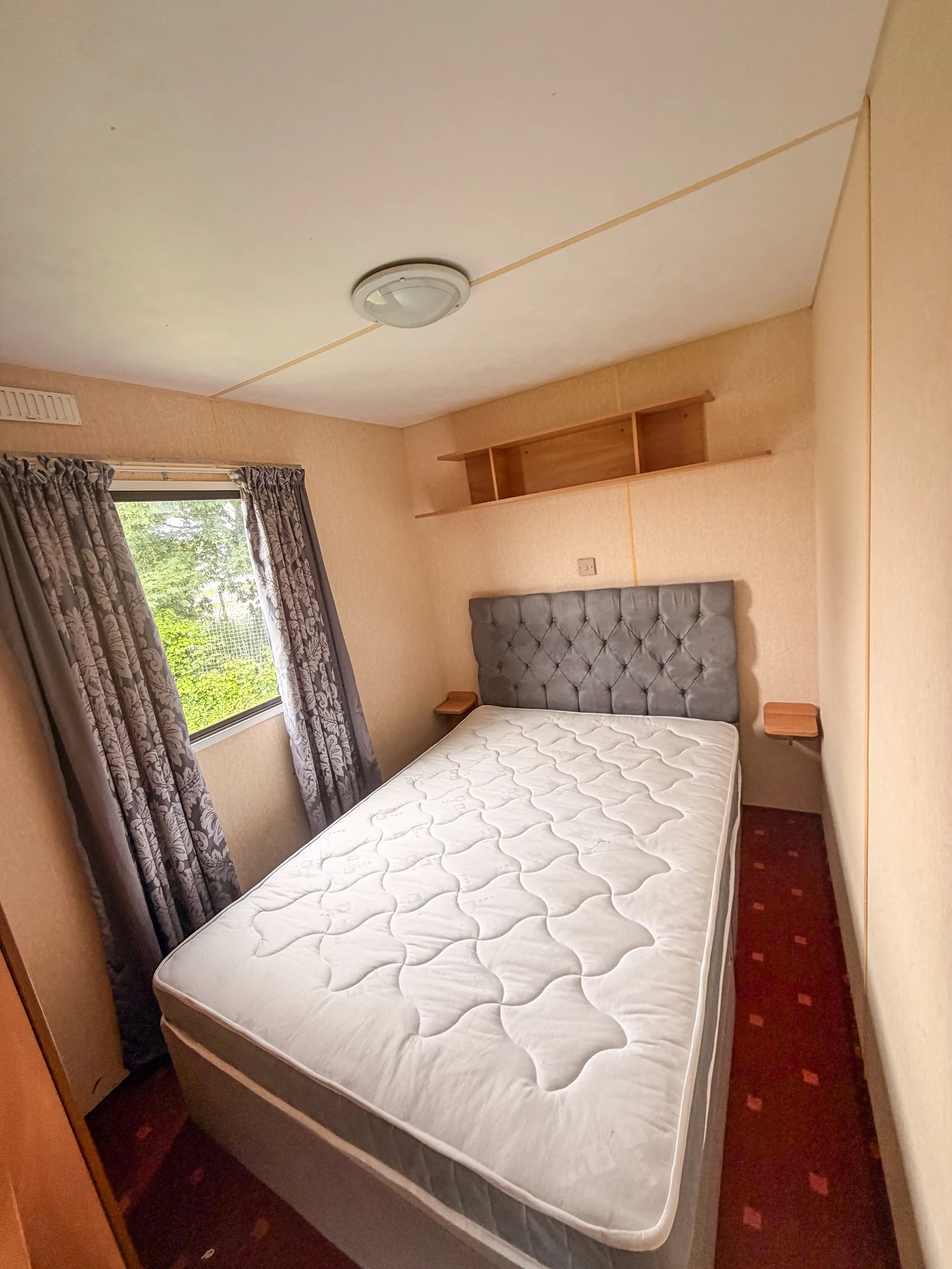 ABI Colorado master bedroom with large bed and overhead shelving