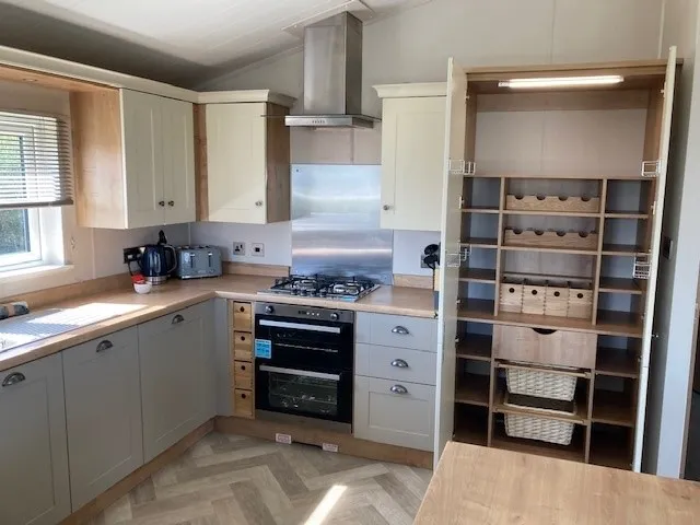 Shaker-style kitchen with integrated appliances in the 2023 Willerby Portland Lodge