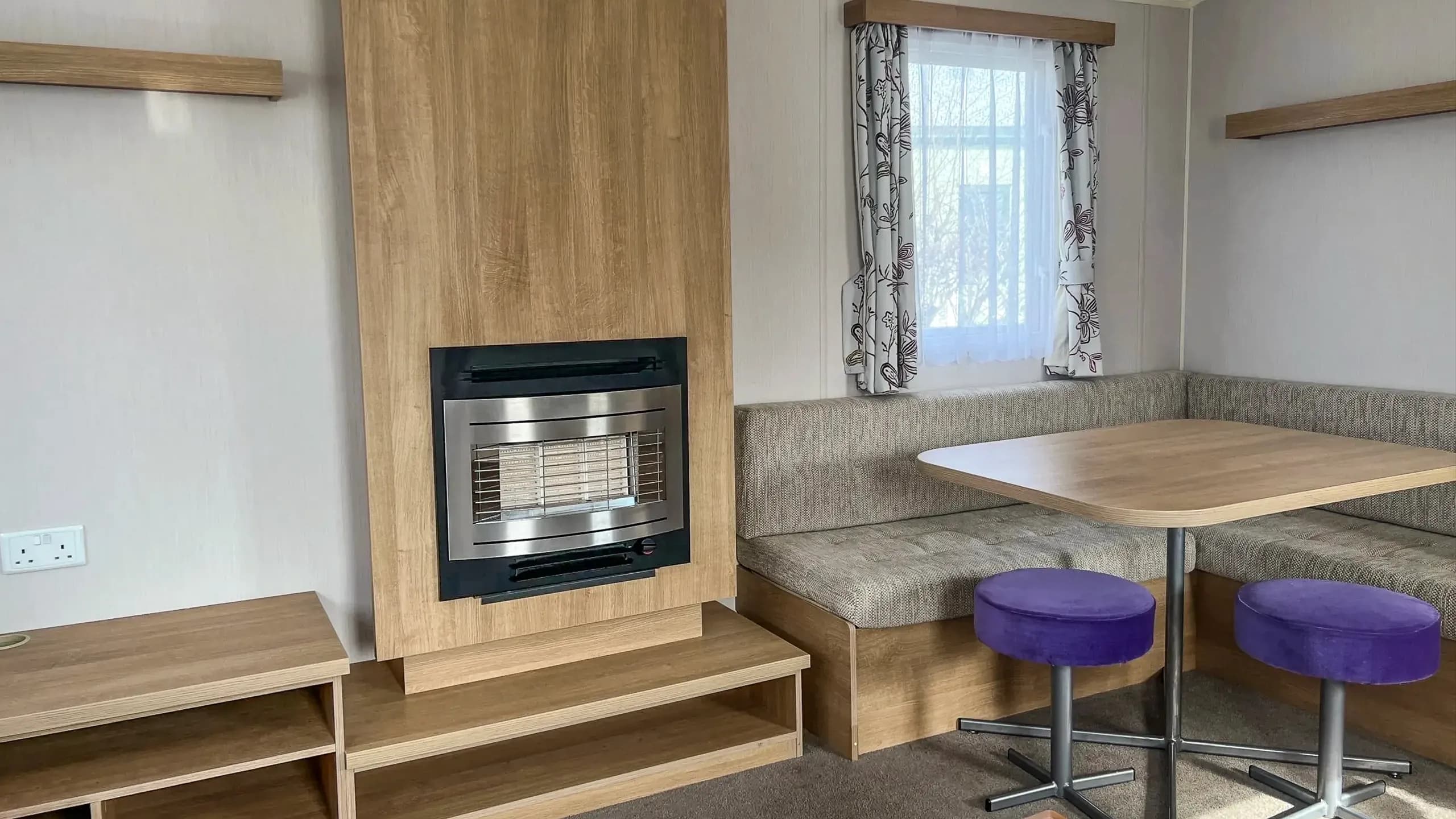 Built in dining area and fireplace with shelving inside 2015 Willerby Vacation Caravan
