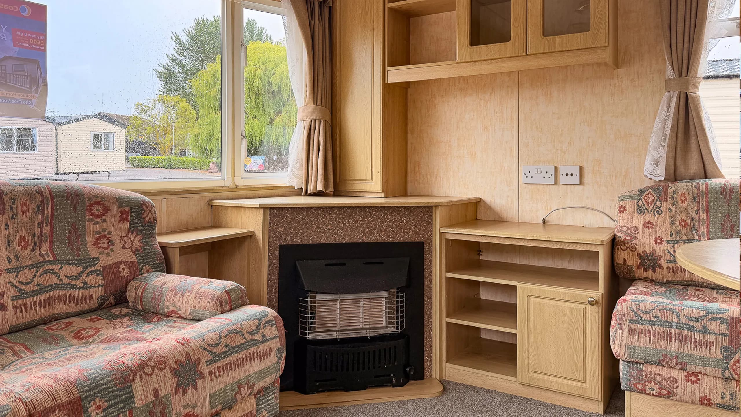 Inside static caravan holiday home fireplace and built in shelfing in oak wood