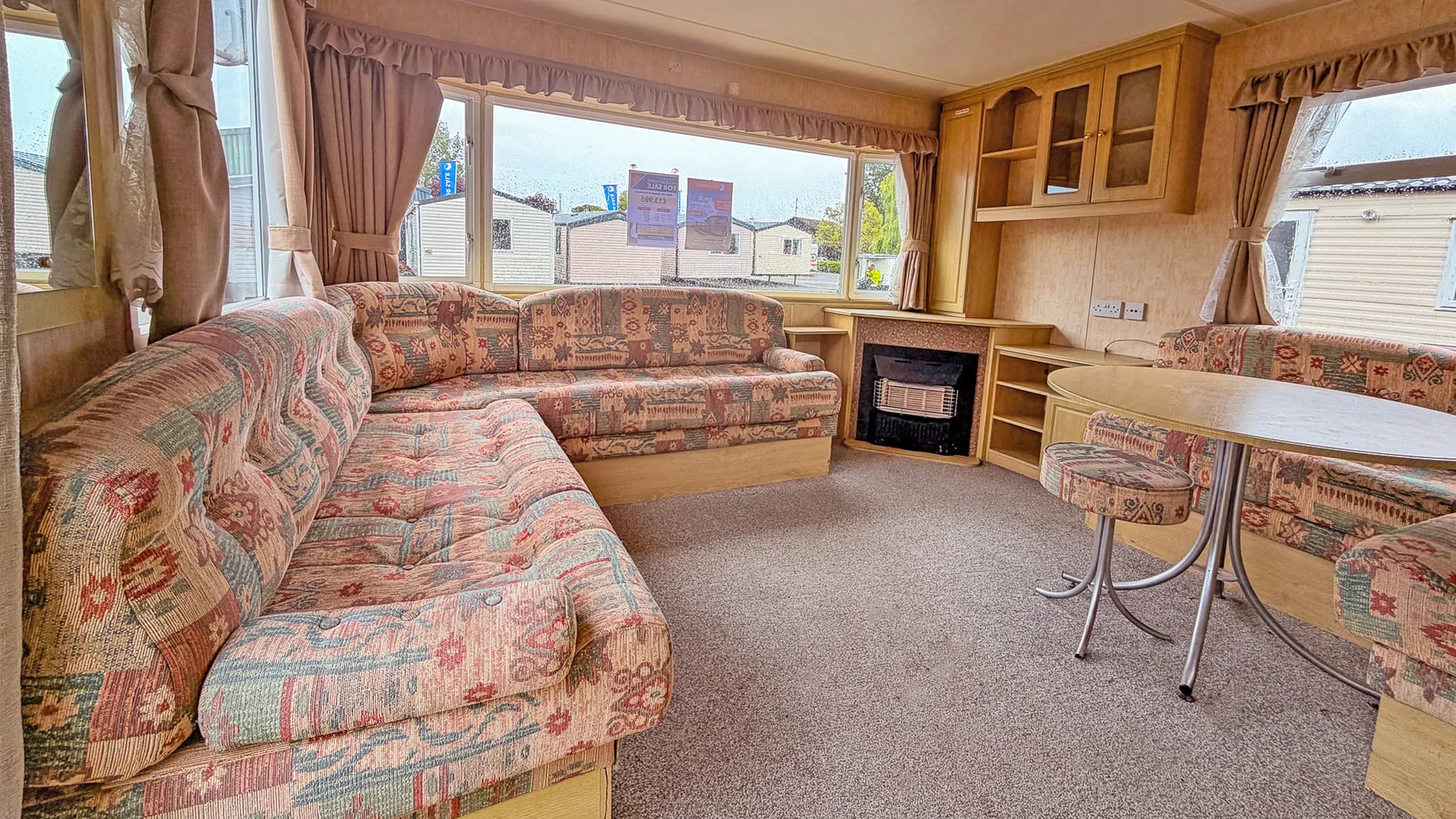 2004 Bluebird Contessa living room with L-shaped sofa and fireplace
