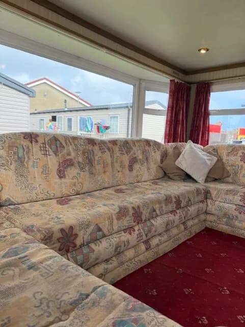 u shaped sofa on a 2002 ABI Lincolnshire with windows behind