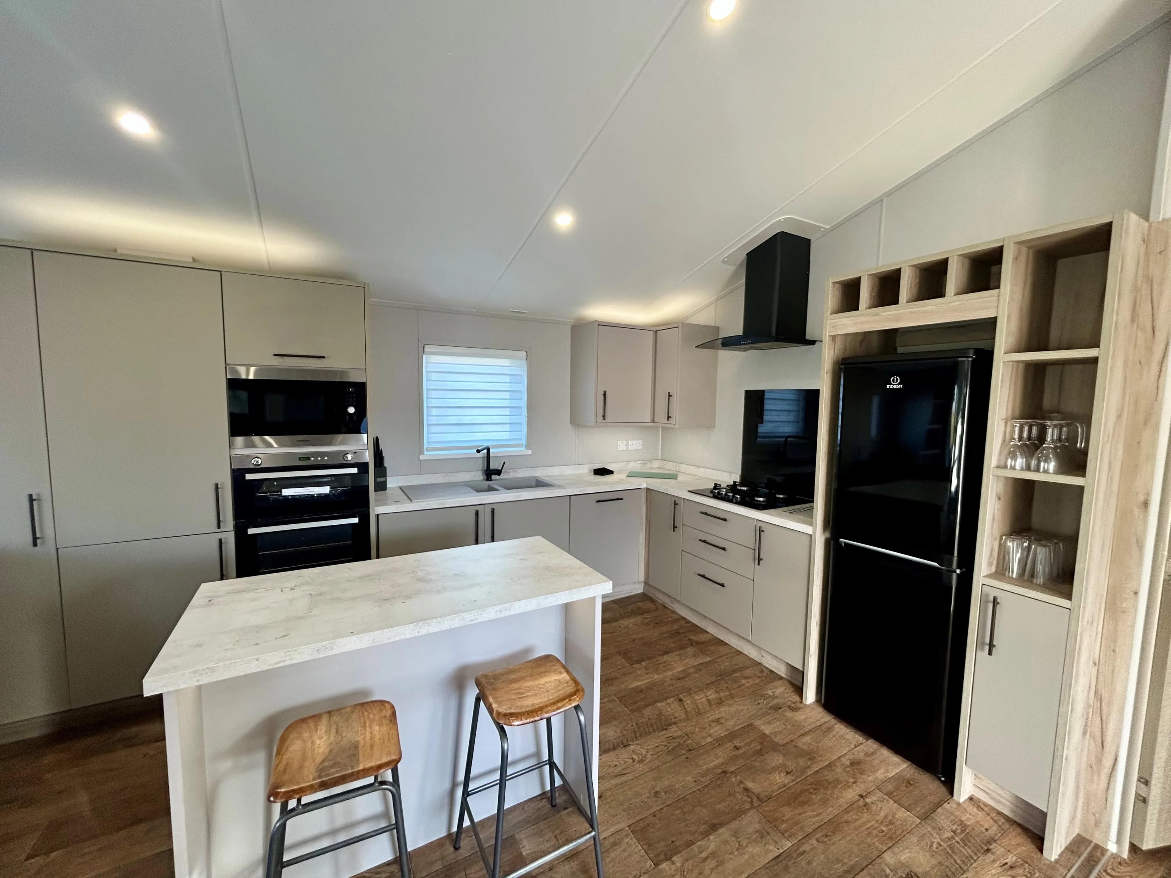 Modern kitchen with central island in the 2021 Willerby Mapleton lodge
