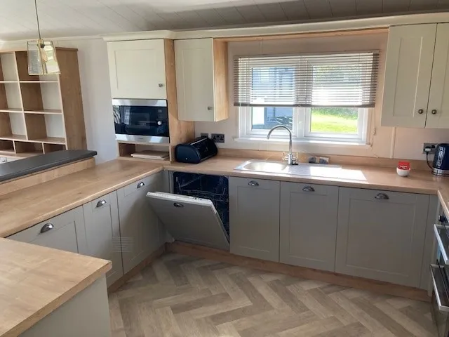 Shaker-style kitchen with integrated appliances in the 2023 Willerby Portland Lodge