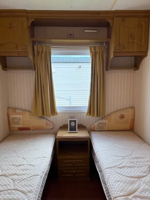 secondary bedroom with two single beds and shared nightstand in the middle on 2002 ABI Lincolnshire