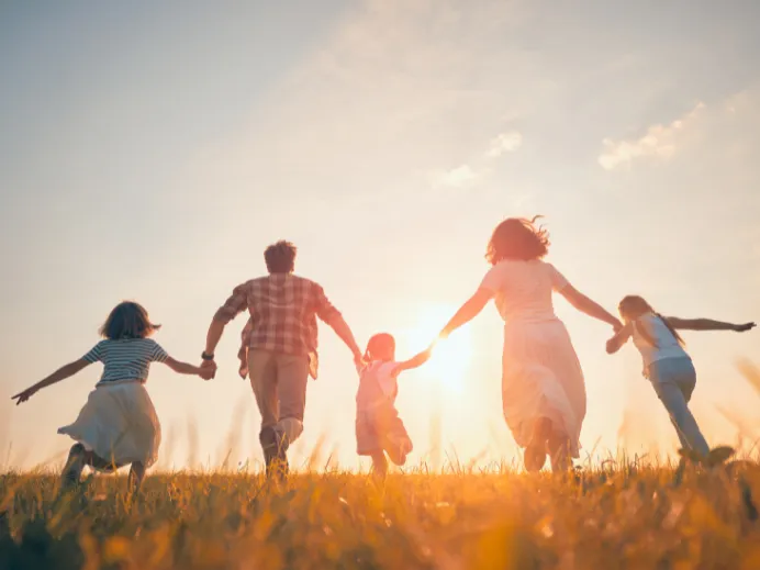 family running into the sunset