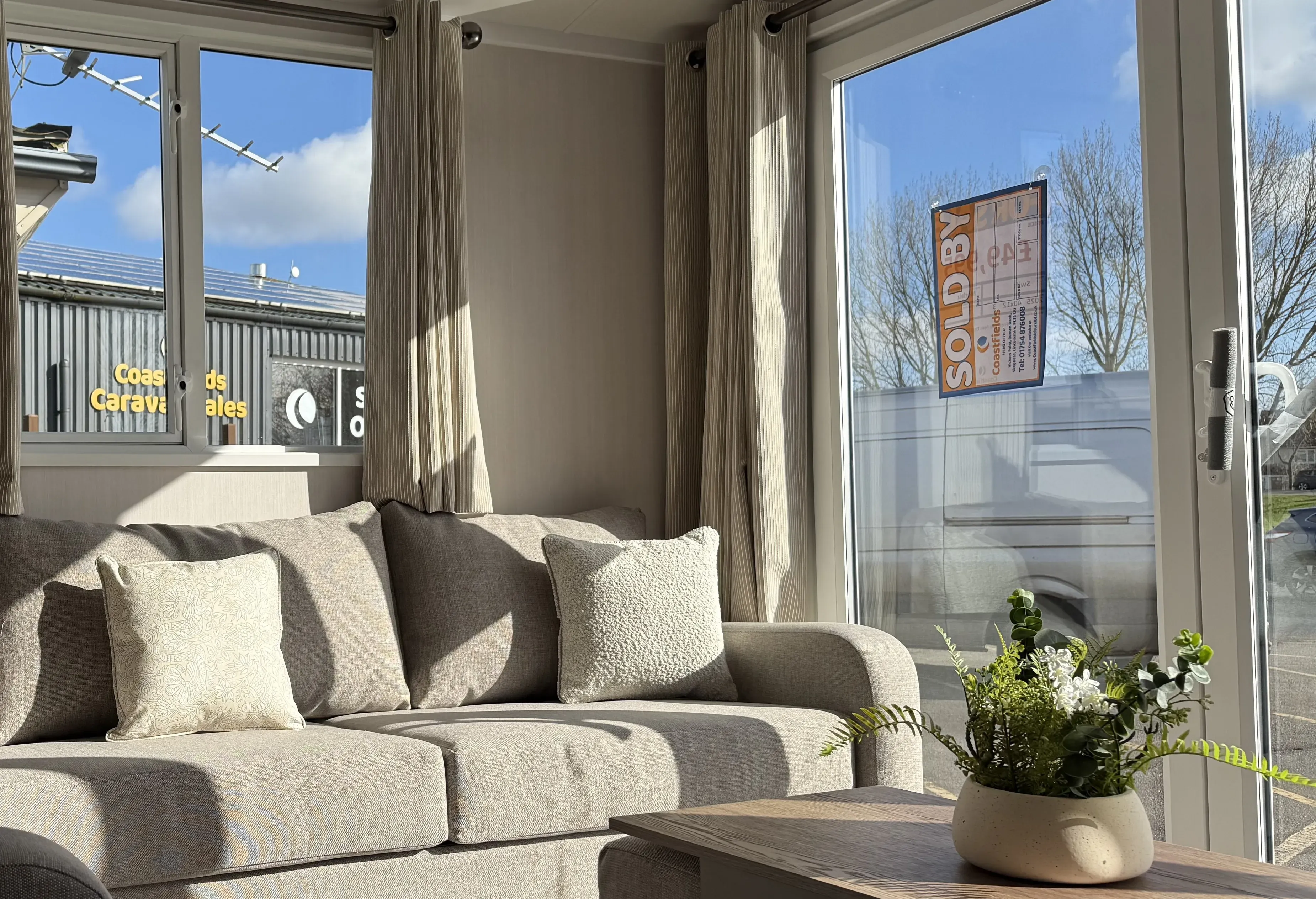 Farmhouse-inspired open-plan lounge inside the 2026 Swift Sienna holiday home.
