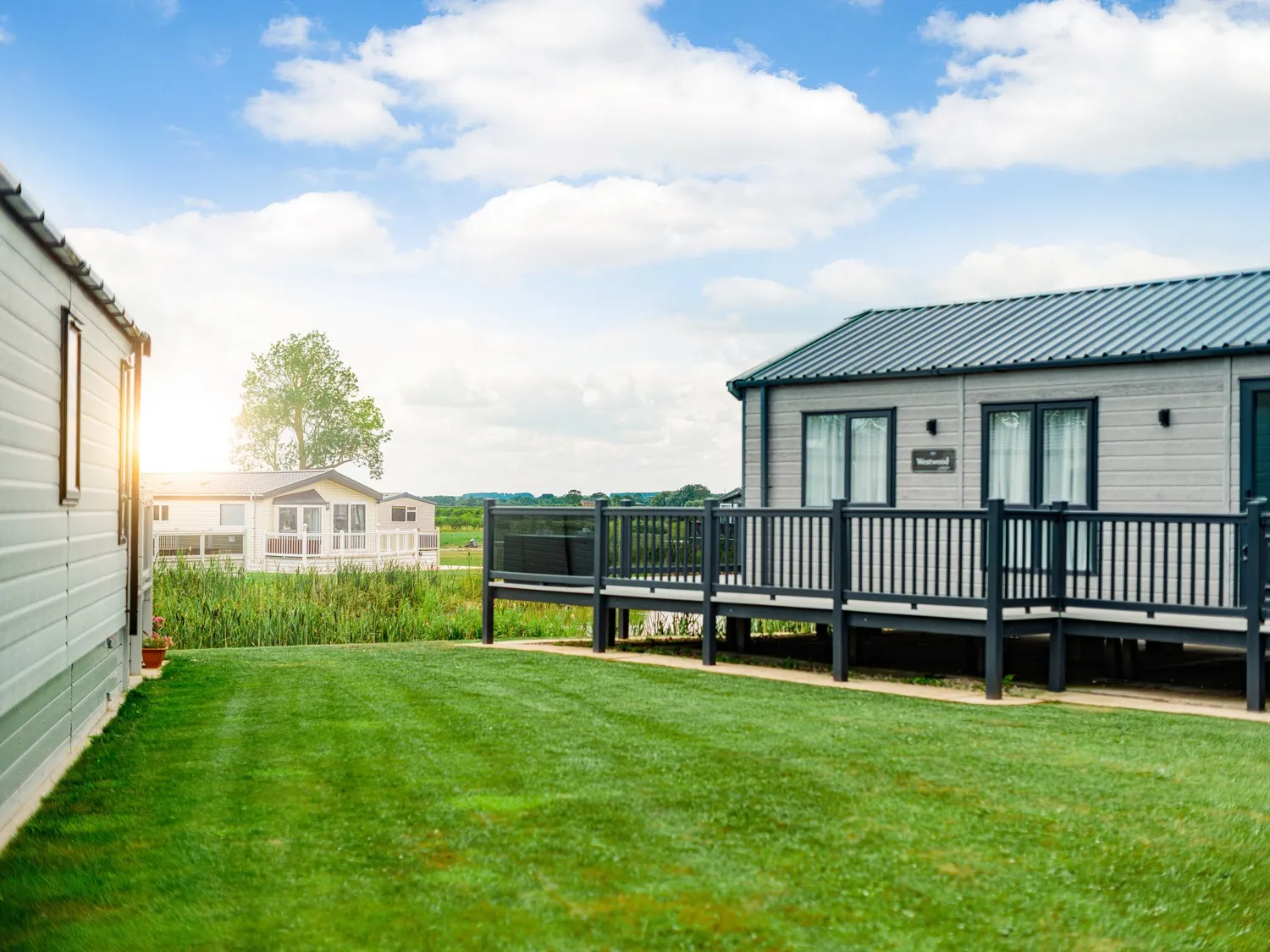 Helsey Farm Caravan with Pond and Sun lit Landscape Behind