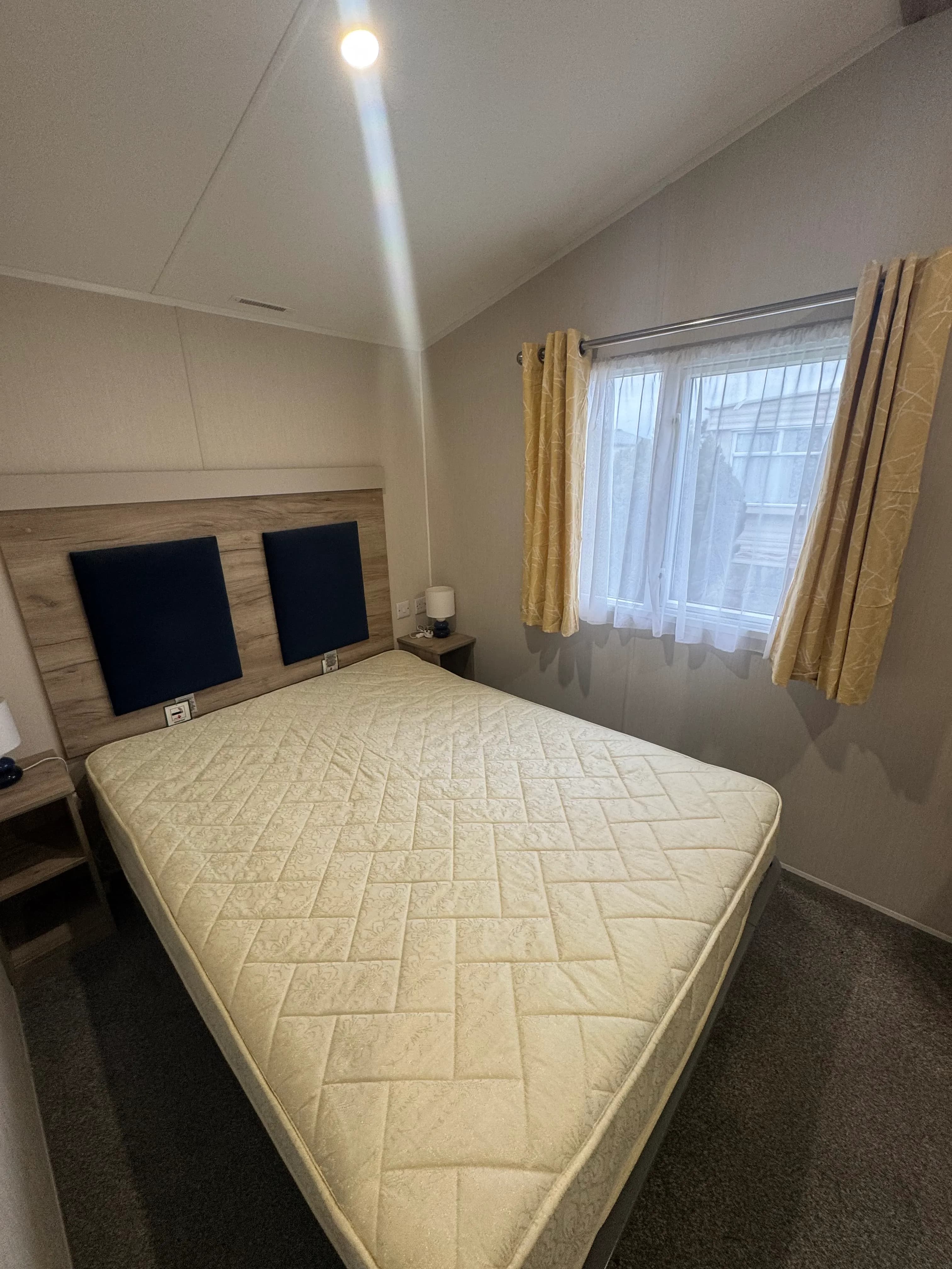 Willerby Linwood bedroom with large bed, side tables and a window