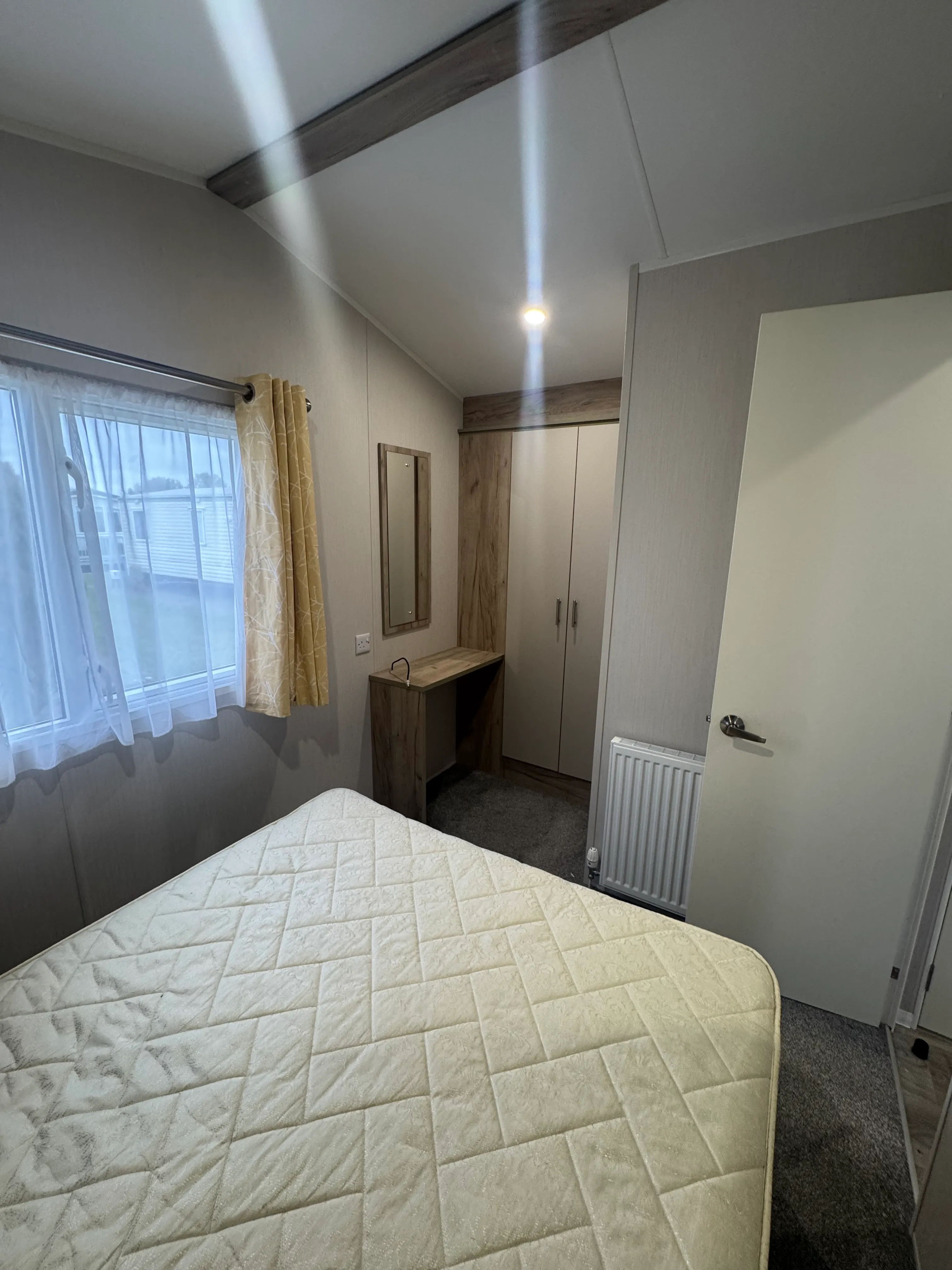 Willerby Linwood bedroom with large bed, dressing table and wardrobe