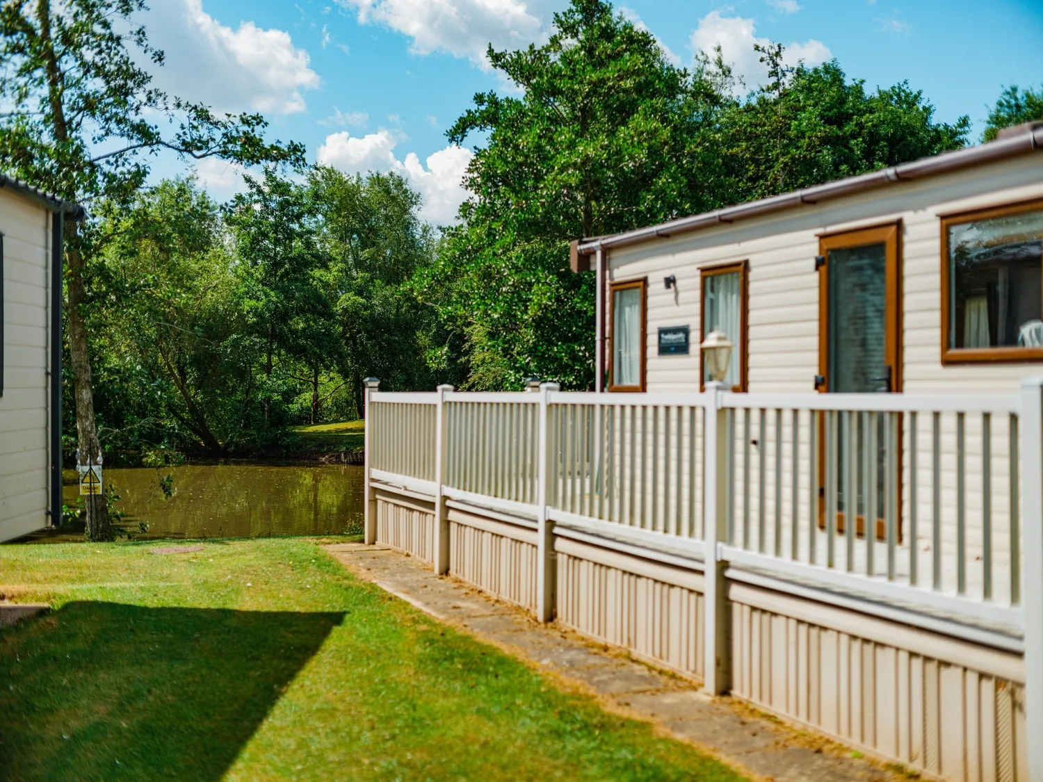 Roach Farm Caravan with Pond in Background Amidst Greenery 2