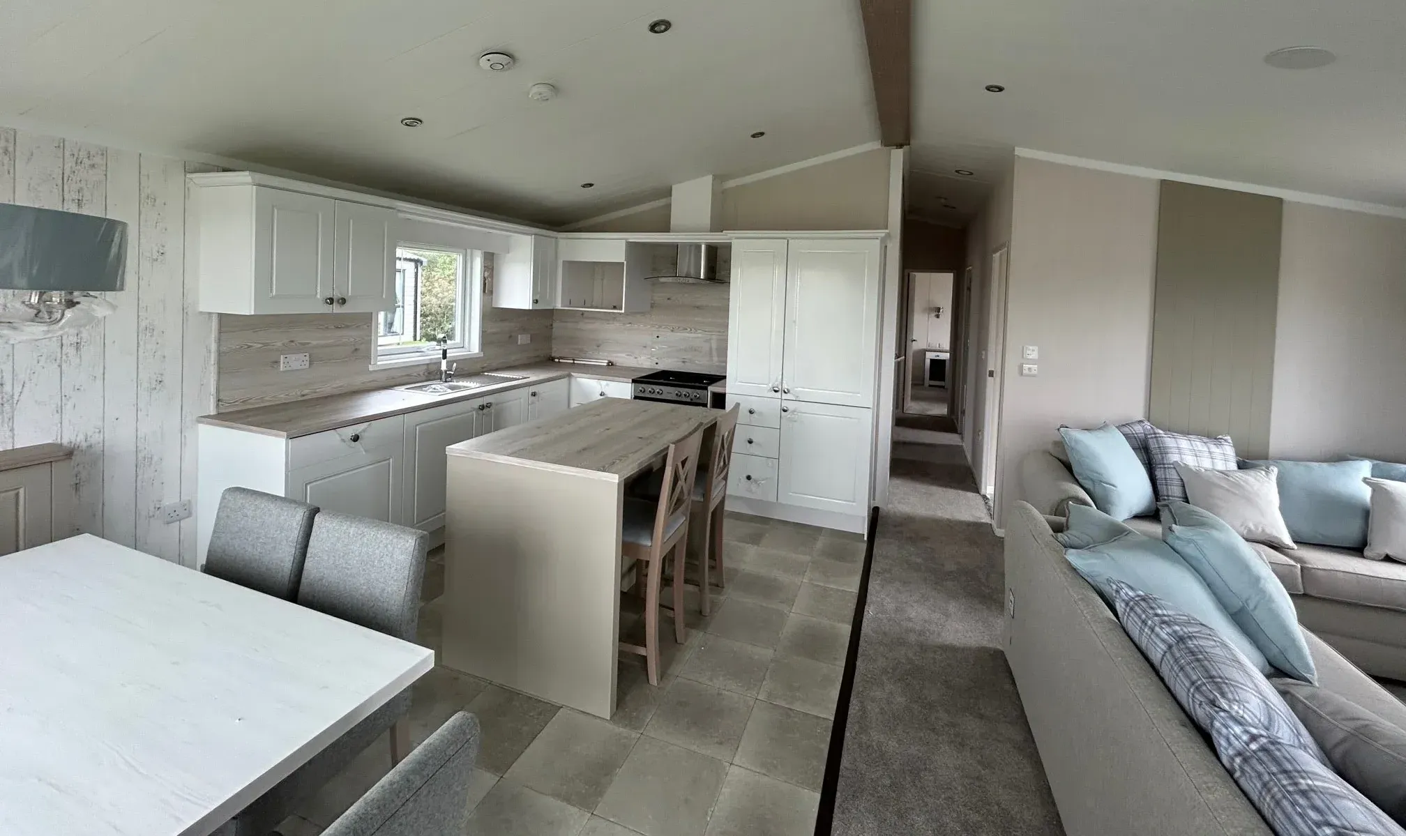 Open-plan living and dining area with floor-to-ceiling windows in the 2023 Swift Edmonton lodge