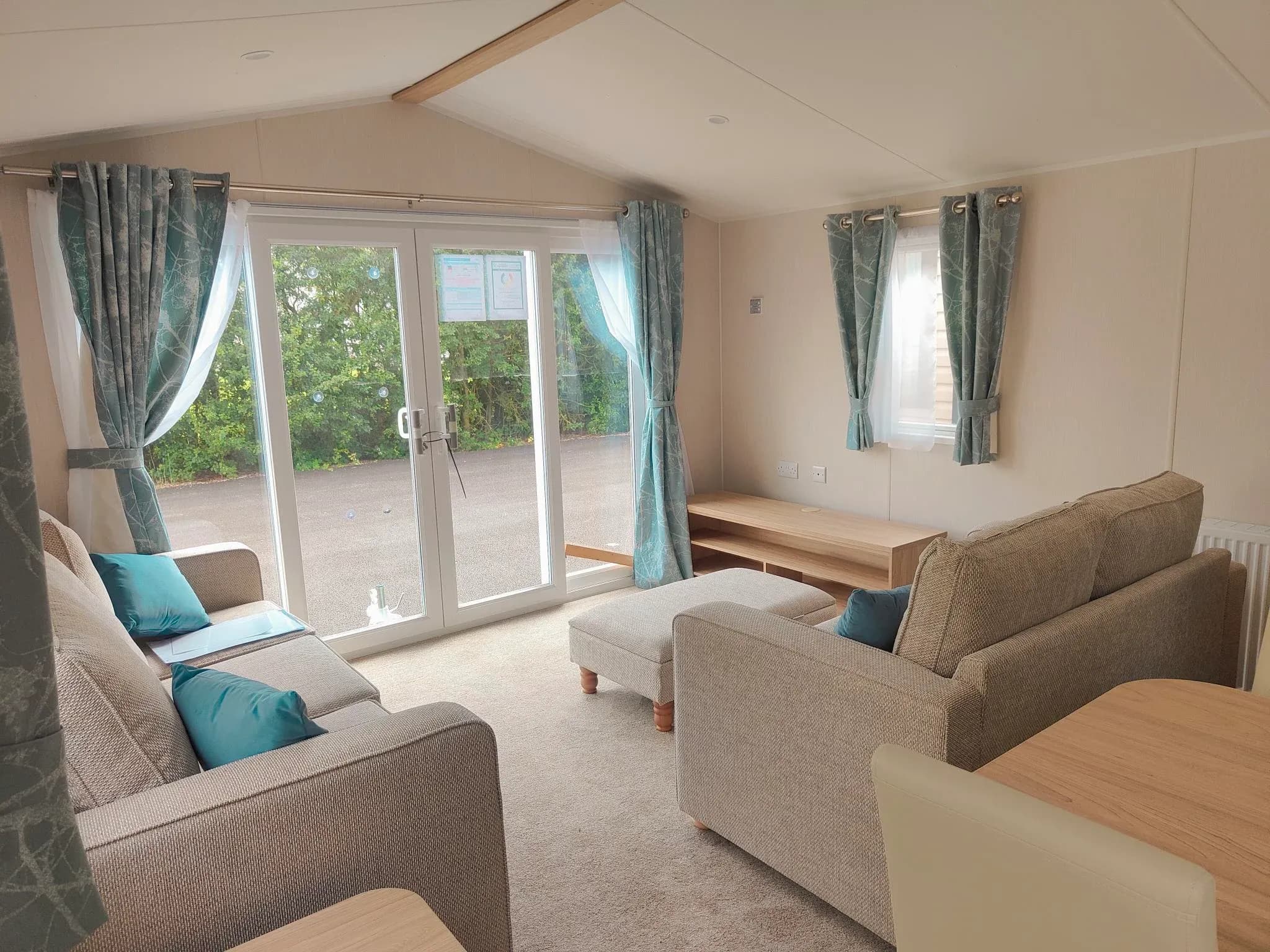 Willerby Malton 35 x 12 x 2 bed 2023 - lounge - freestanding sofa - patio doors - curtains