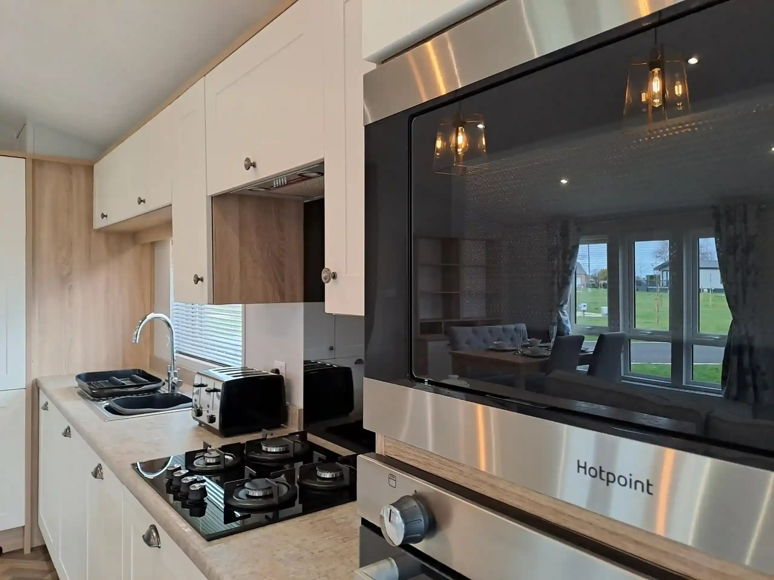 Modern kitchen with integrated appliances in the 2022 Willerby Pinehurst Lodge
