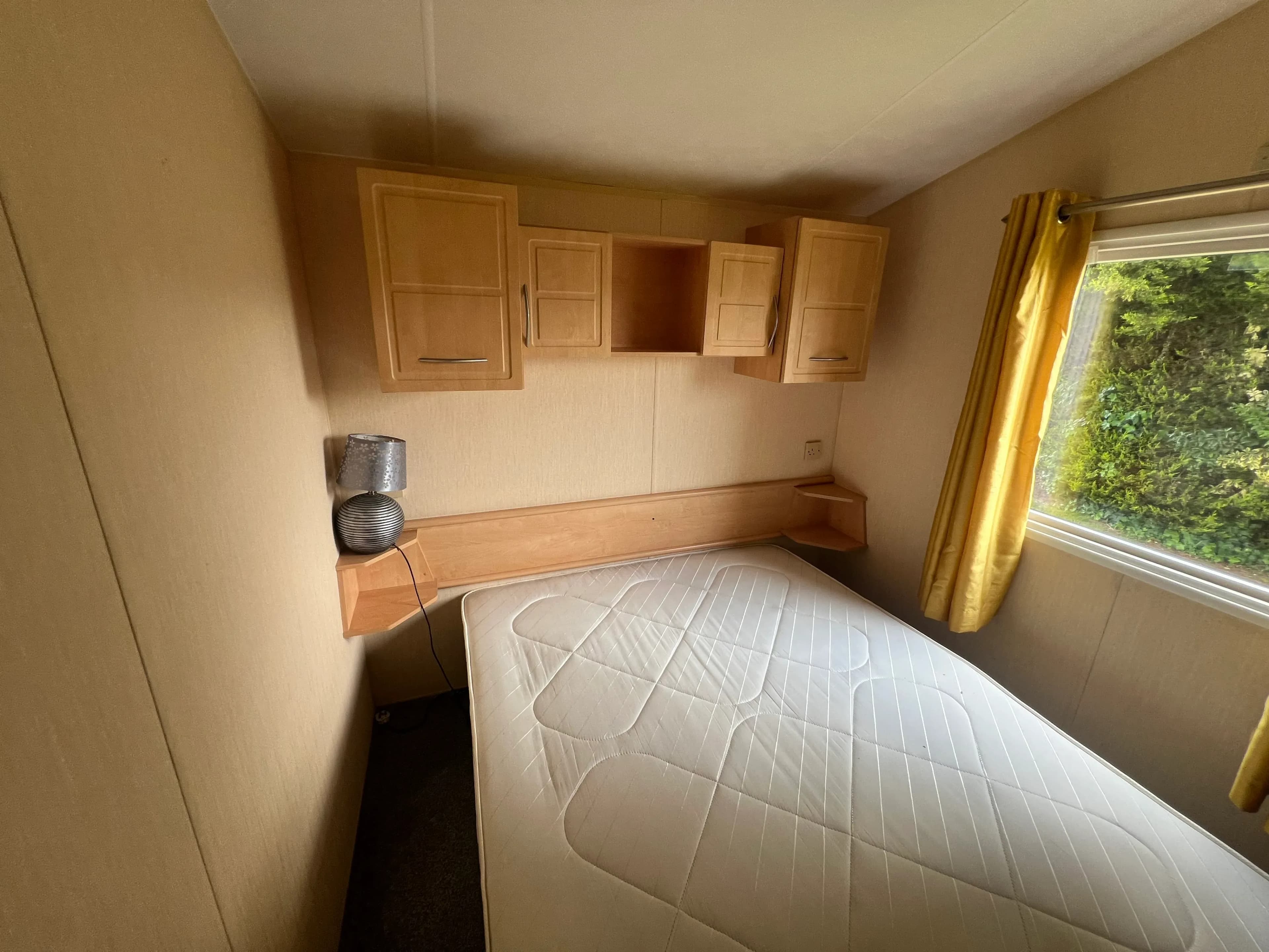 Master bedroom with fitted storage in the 2012 Willerby Rio Gold