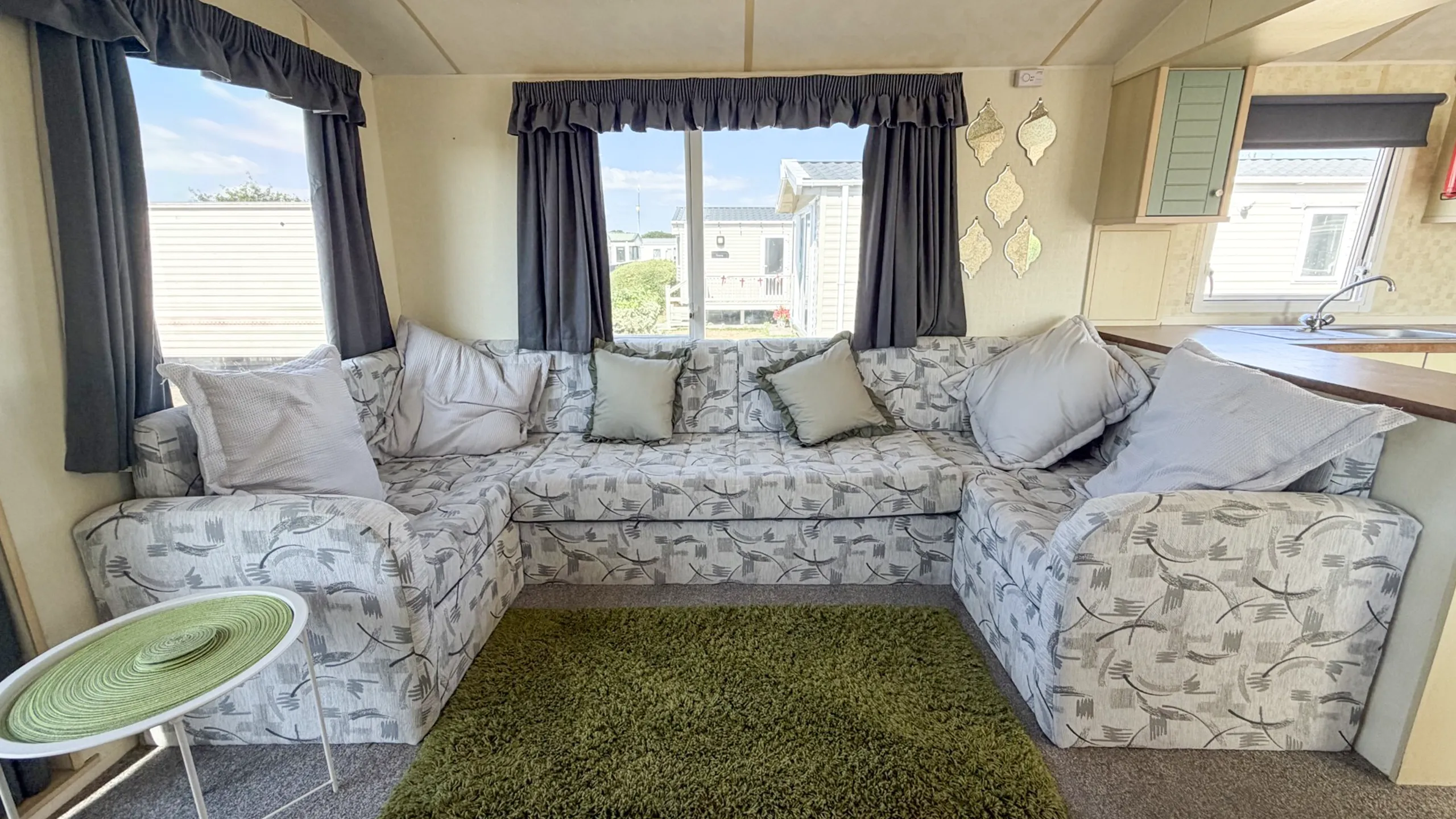 Spacious lounge inside the 2007 Atlas Lakeland Super holiday home with comfortable family seating.