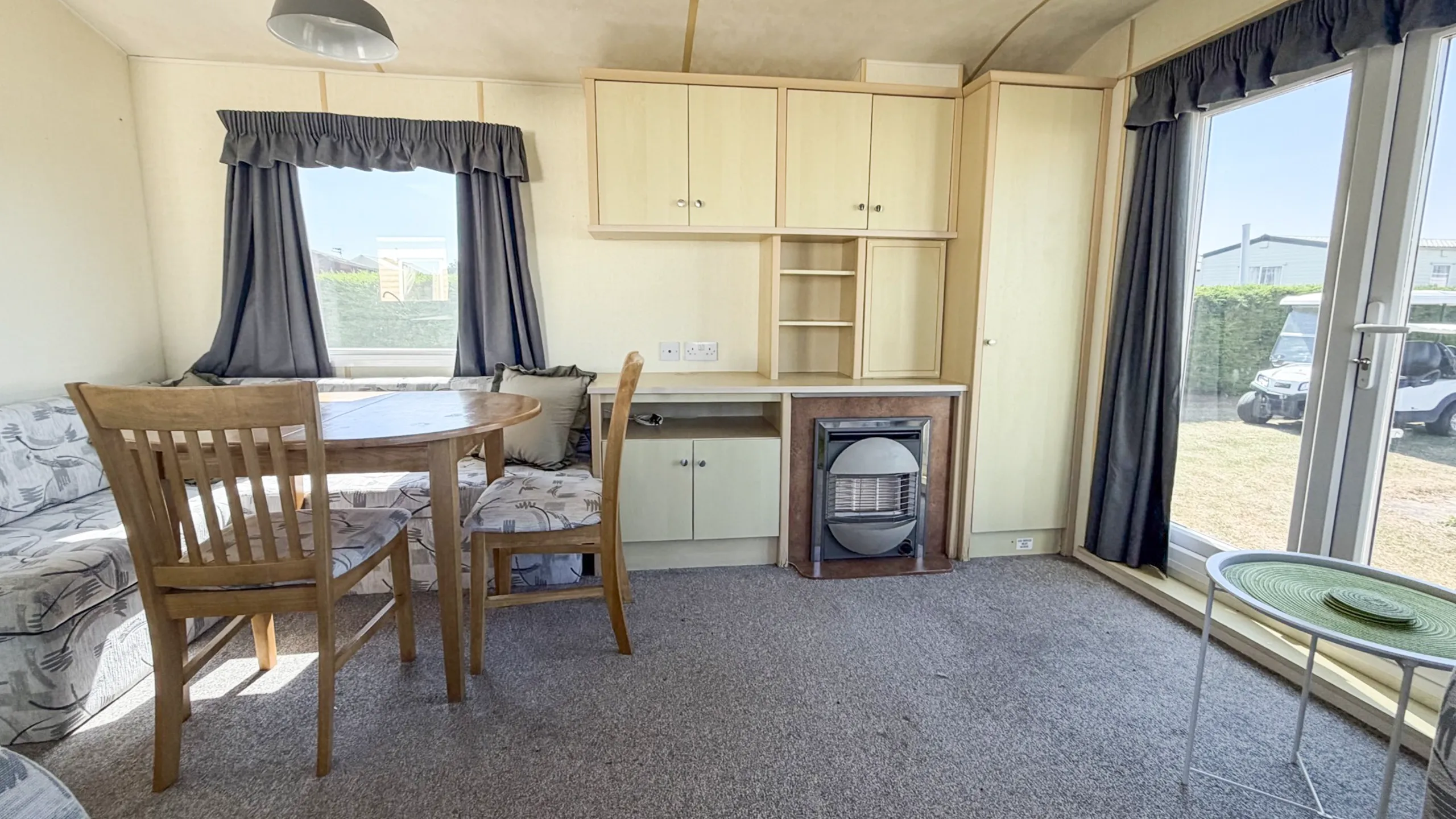 Spacious lounge inside the 2007 Atlas Lakeland Super holiday home with comfortable family seating.