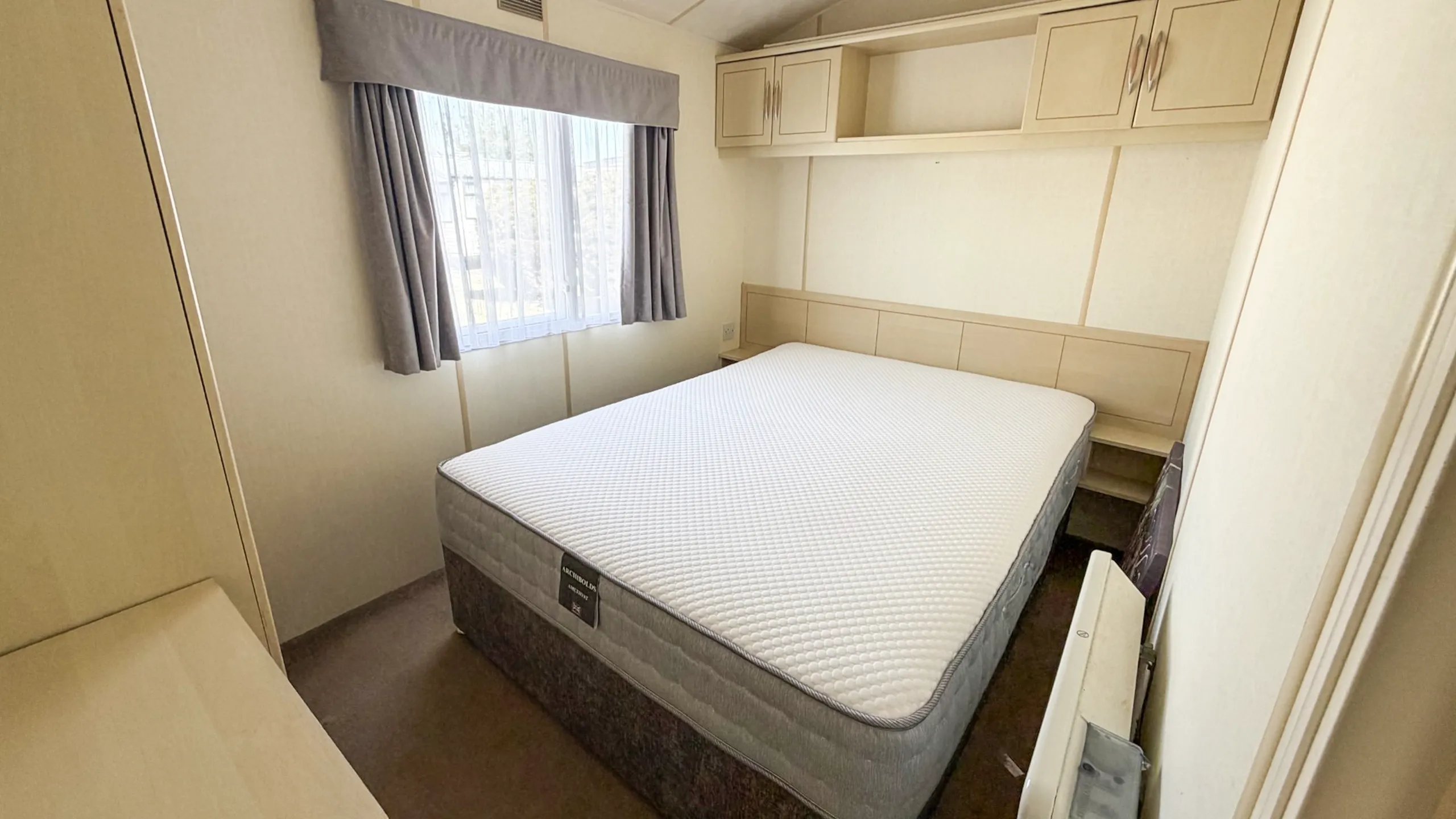 Comfortable master bedroom in the 2007 Atlas Lakeland Super static caravan.