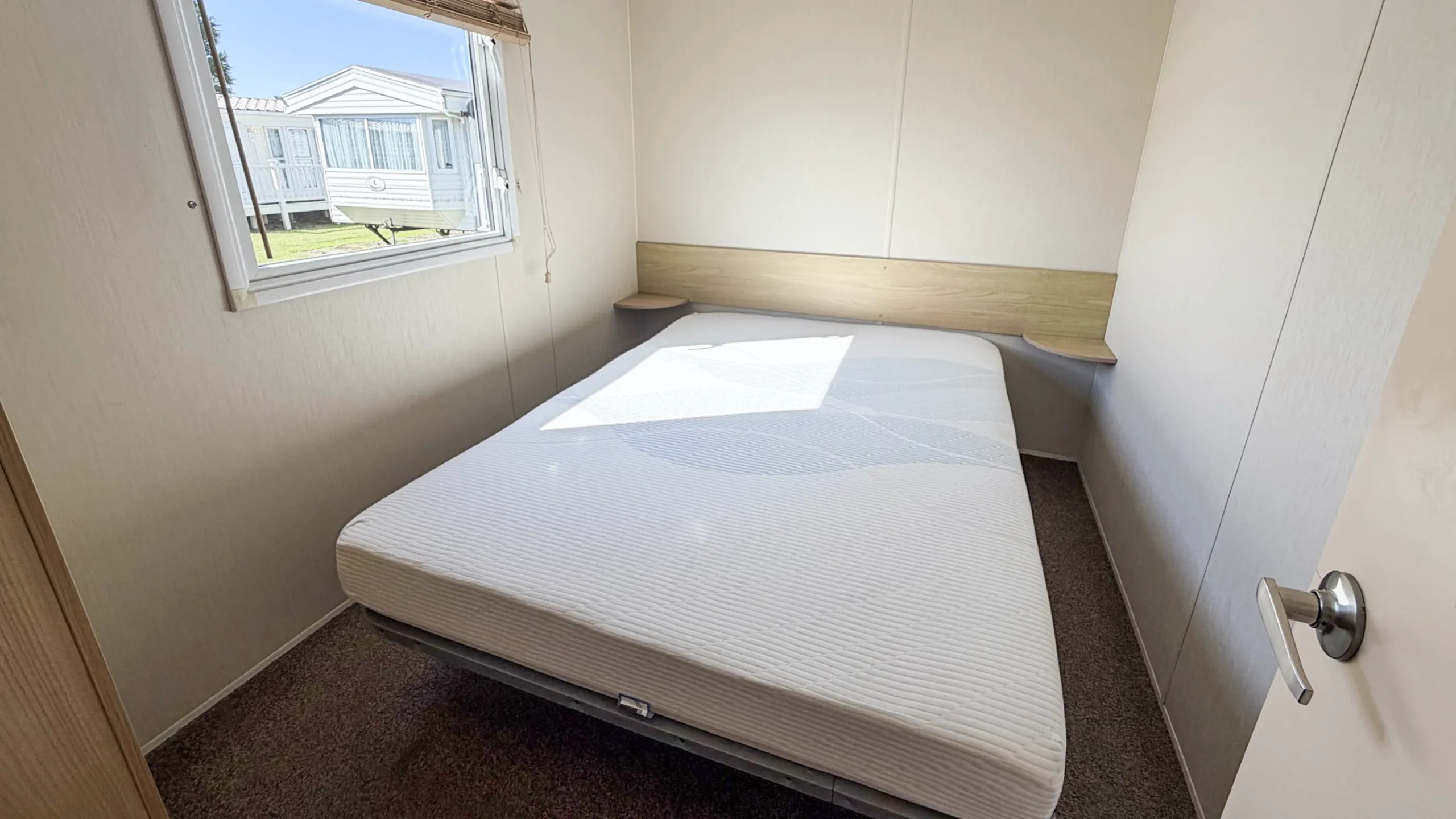 Spacious master bedroom with storage in the 2015 Willerby Aurora.