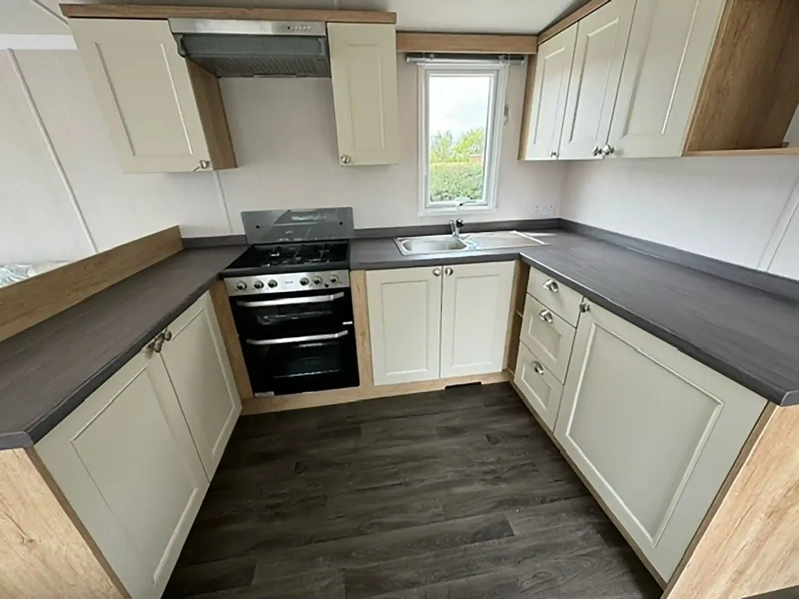 Modern kitchen in the 2023 Swift Burgundy with integrated microwave and fridge freezer