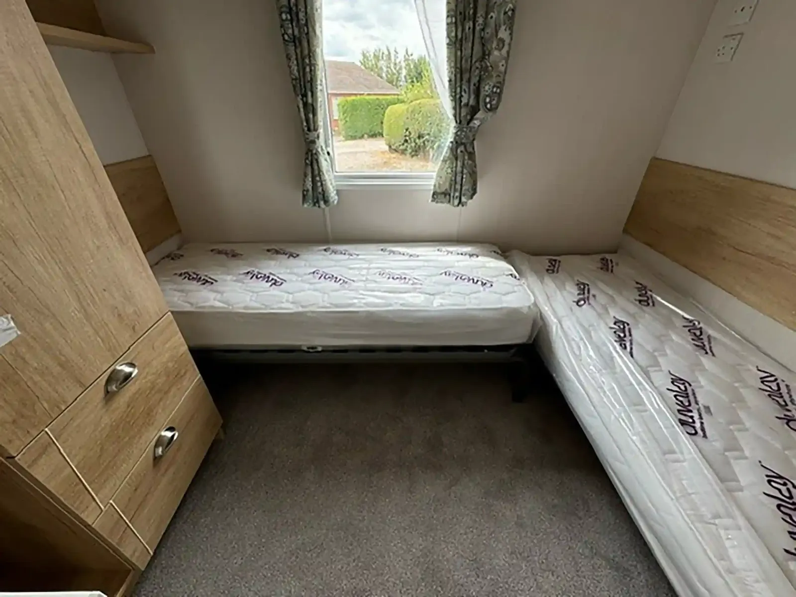 Twin bedroom with single beds in the 2023 Swift Burgundy holiday home