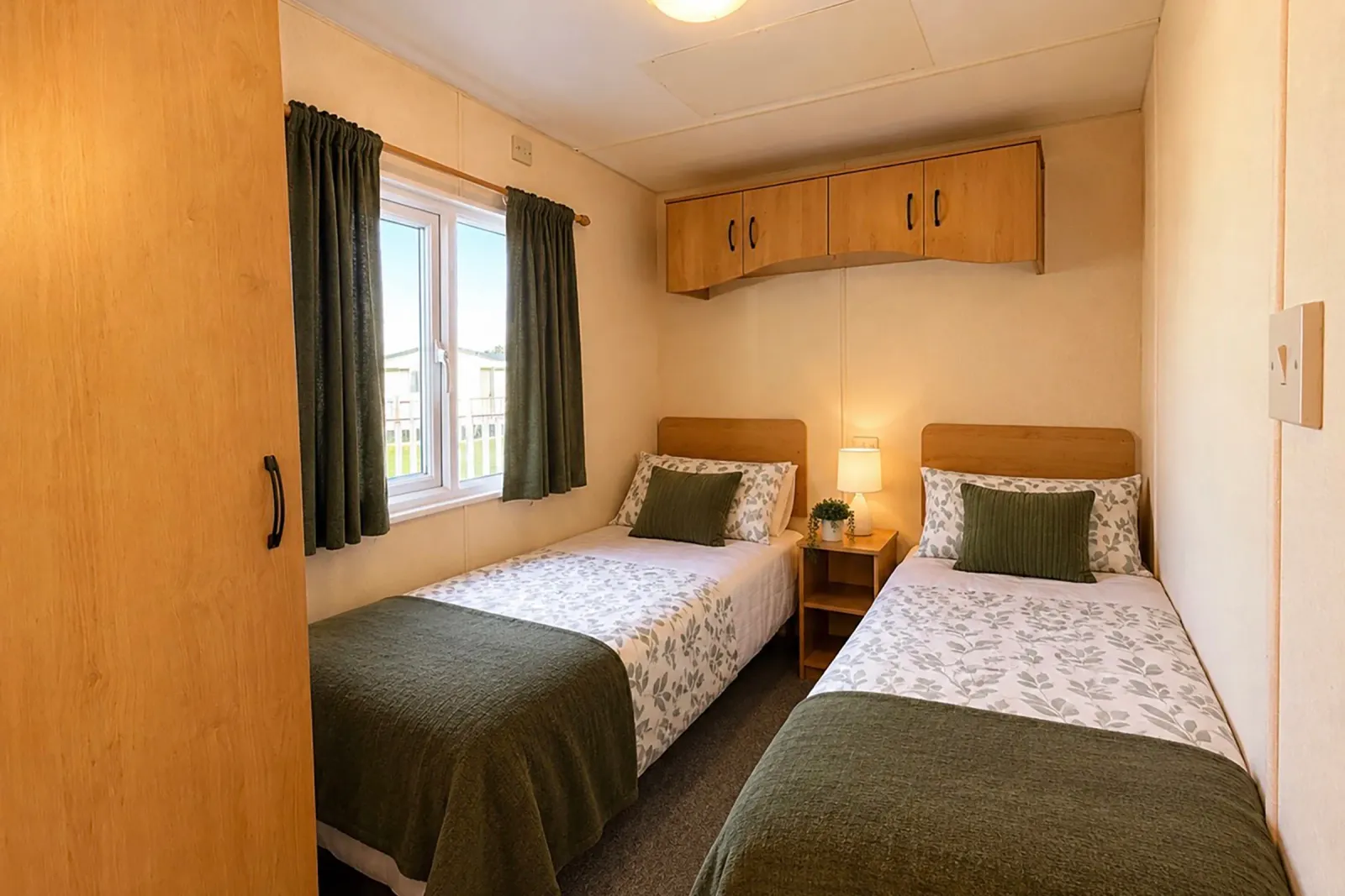 Twin bedroom with two single beds and fitted storage in the Cosalt Torbay static caravan
