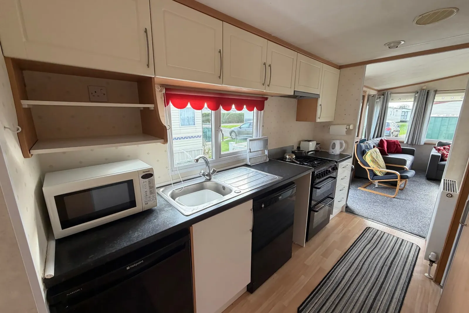 Fitted galley-style kitchen with storage cupboards and cooking facilities in the Pemberton Sovereign