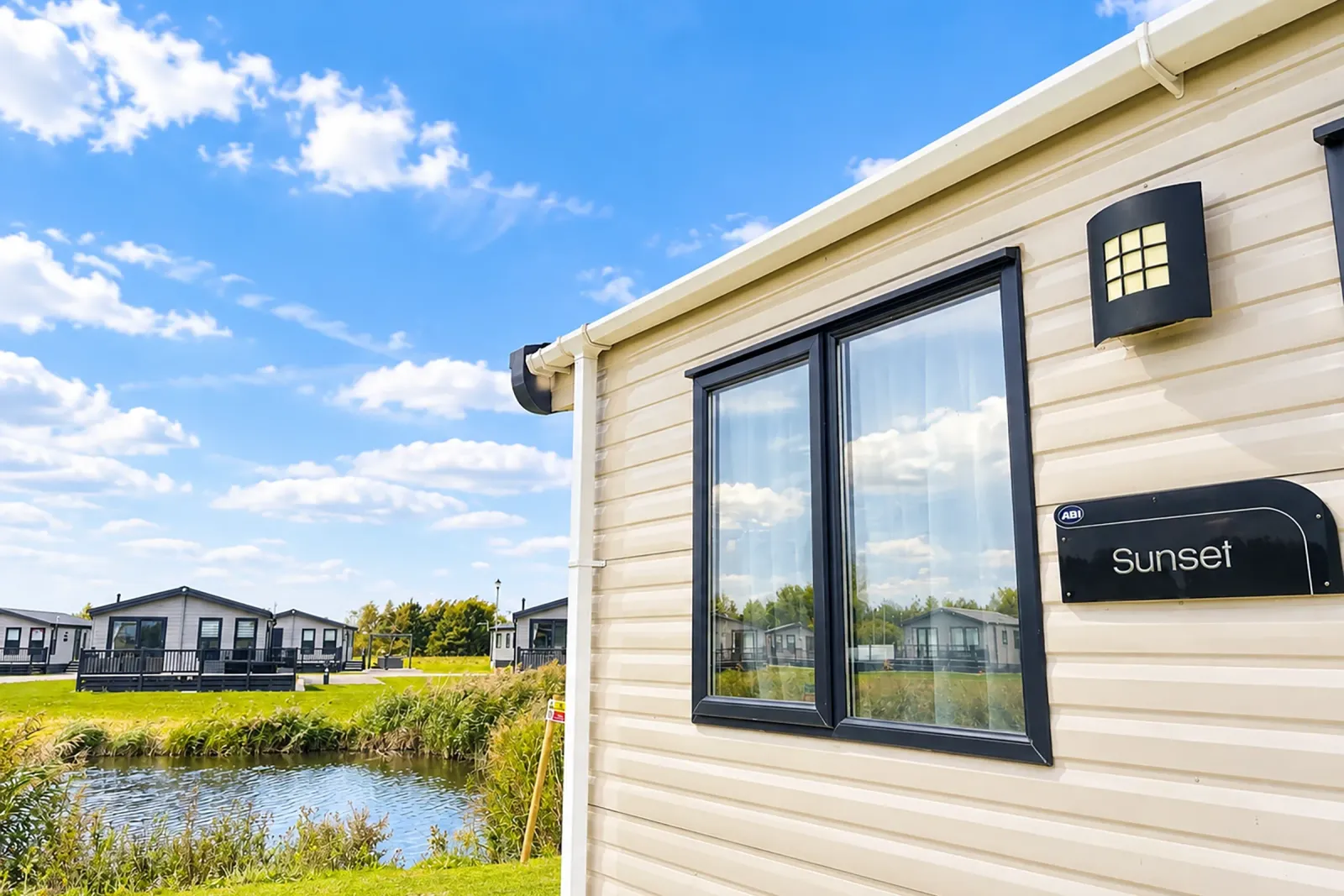 2016 ABI Sunset Coastfields exterior situated beside fishing lake at Grange Leisure Park