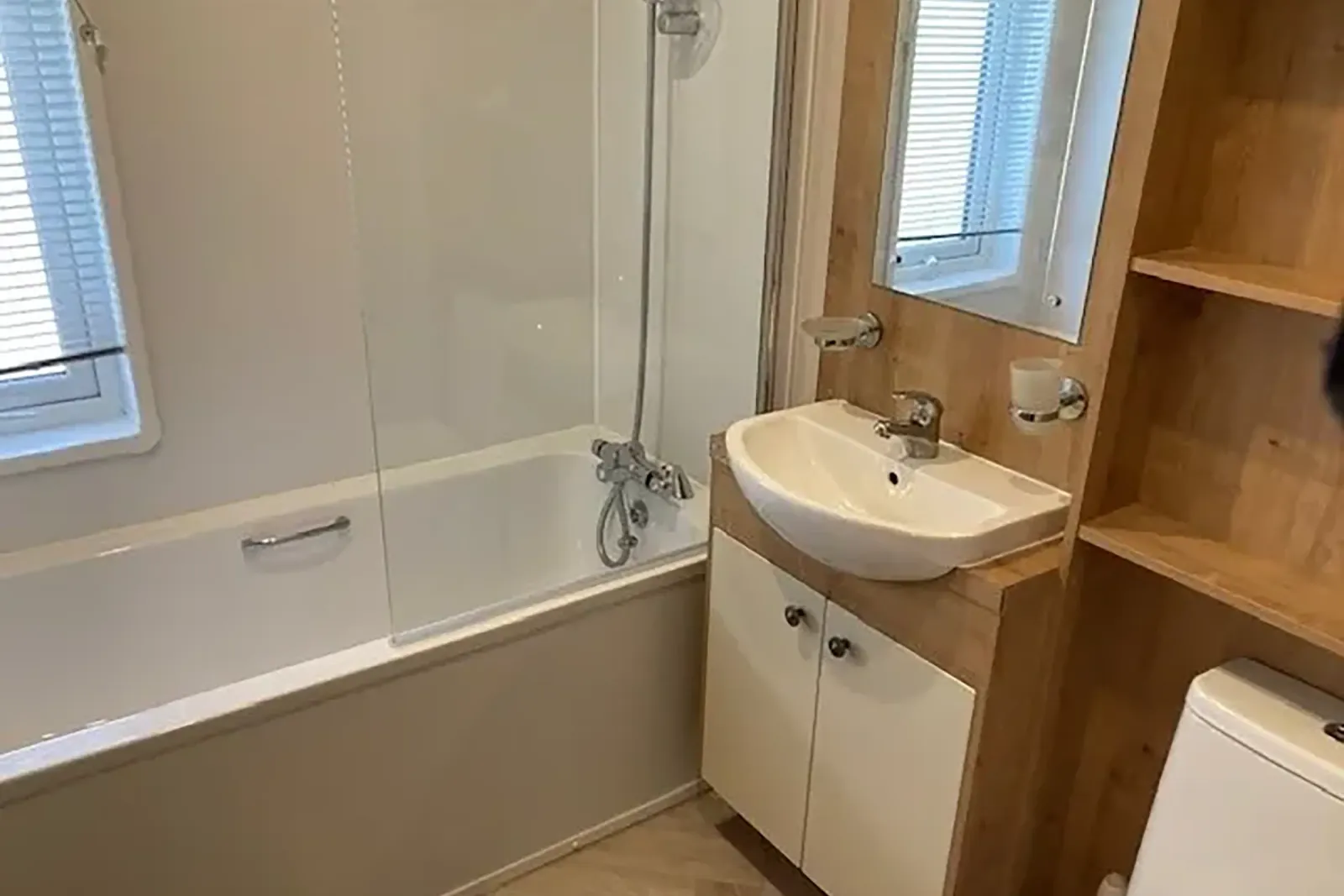 Family bathroom with bathtub, shower and fitted vanity unit in the 2023 Willerby Portland Lodge