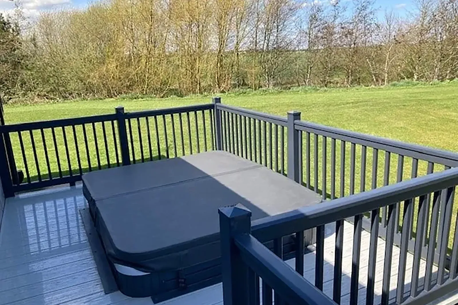 Private outdoor hot tub on the deck of the 2023 Willerby Portland Lodge at Grange Leisure Park