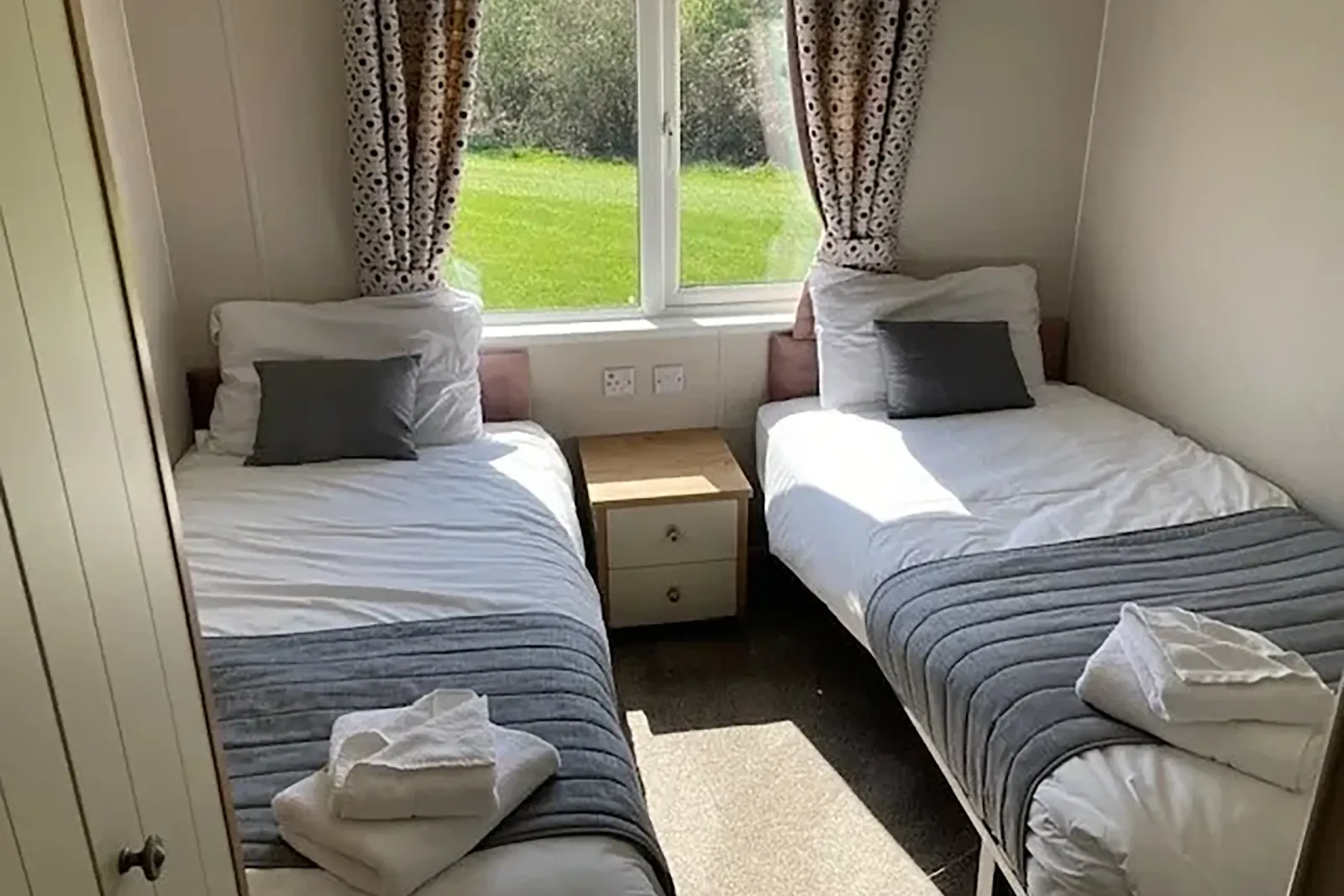 Twin bedroom with two single beds and garden views in the 2023 Willerby Portland Lodge