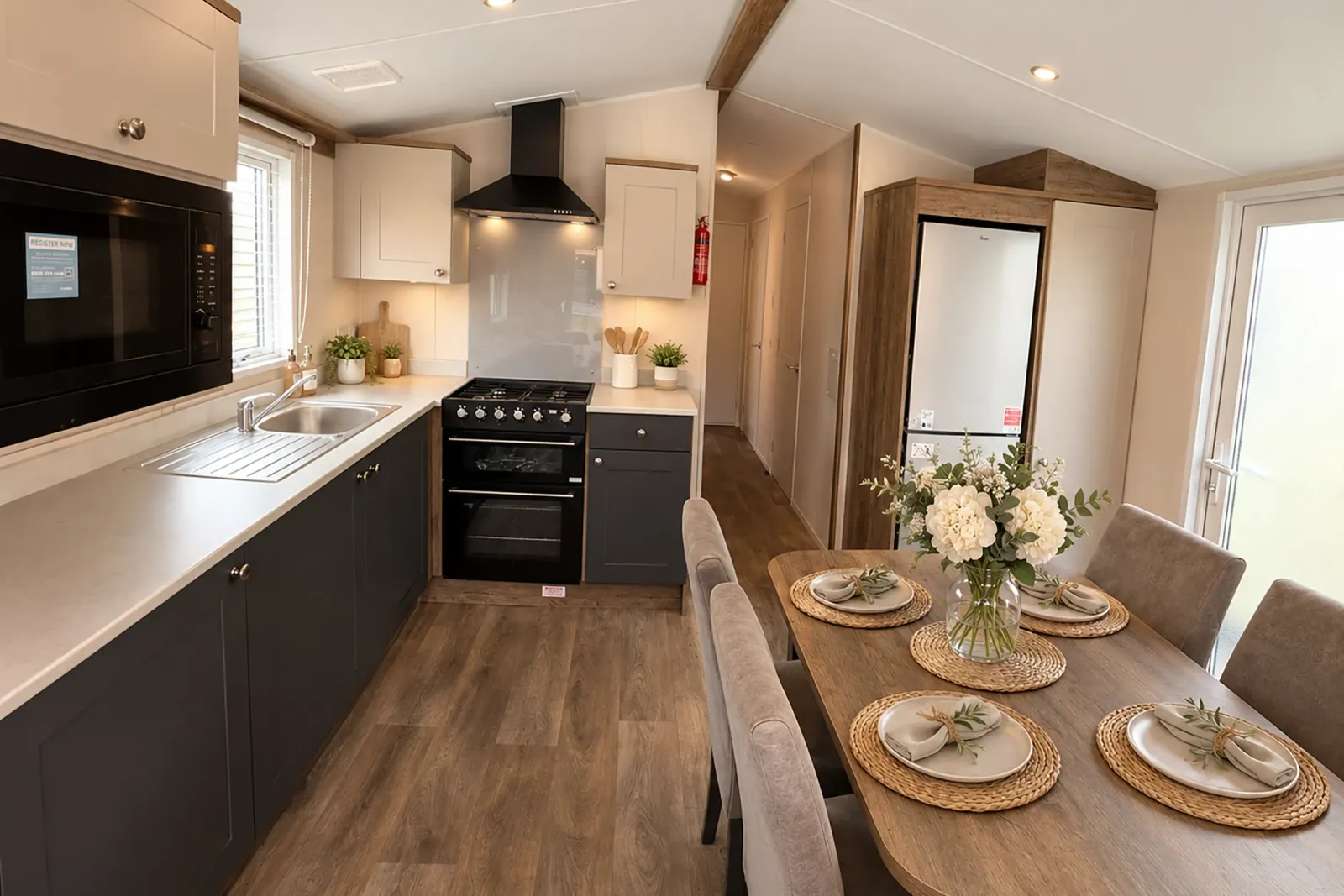 Contemporary kitchen and dining area with dark cabinets and dining table in the brand-new 2026 Willerby Malton