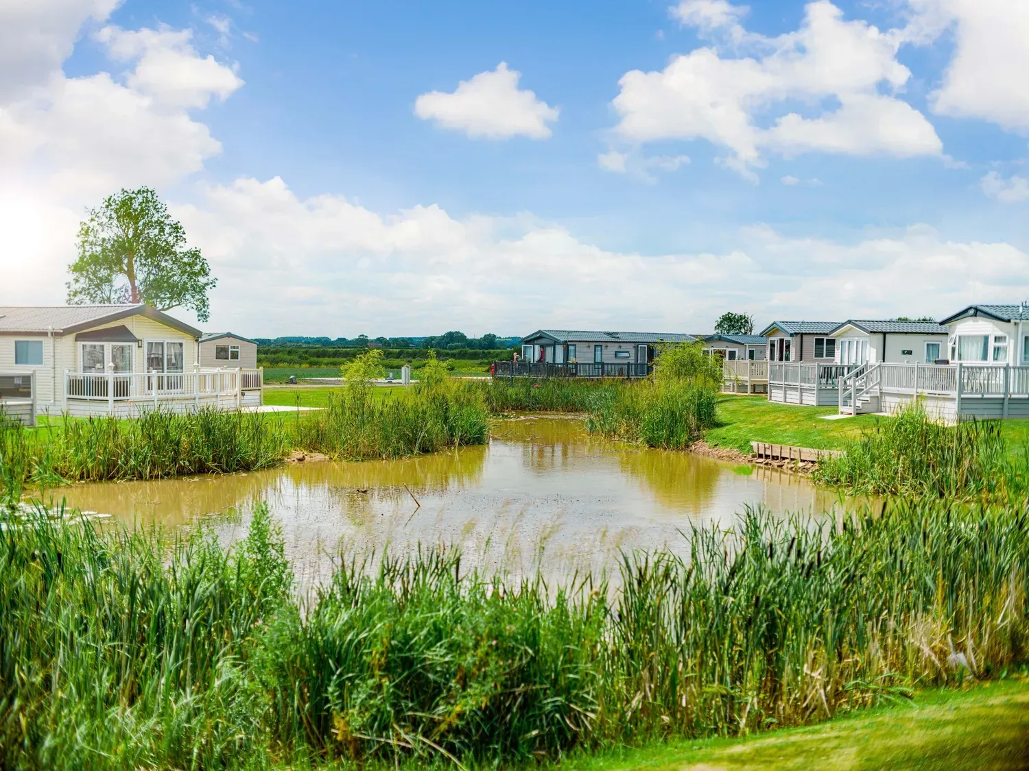 Helsey Farm pond with Caravans and Greenery 2
