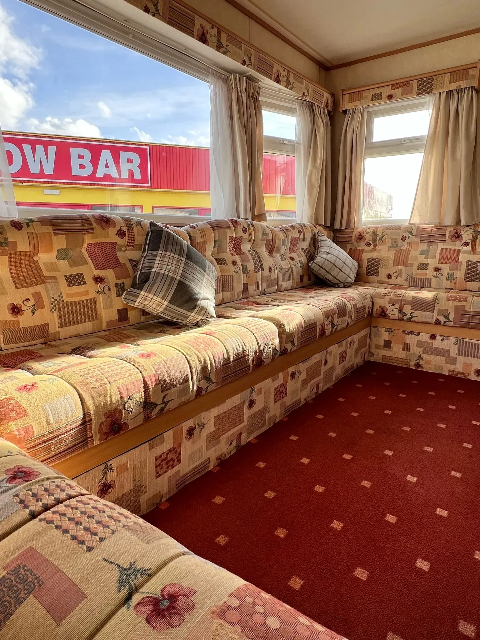 u shaped sofa on a 2008 ABI Colorado with windows behind
