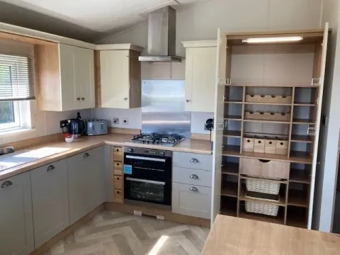 Shaker-style kitchen with integrated appliances in the 2023 Willerby Portland Lodge